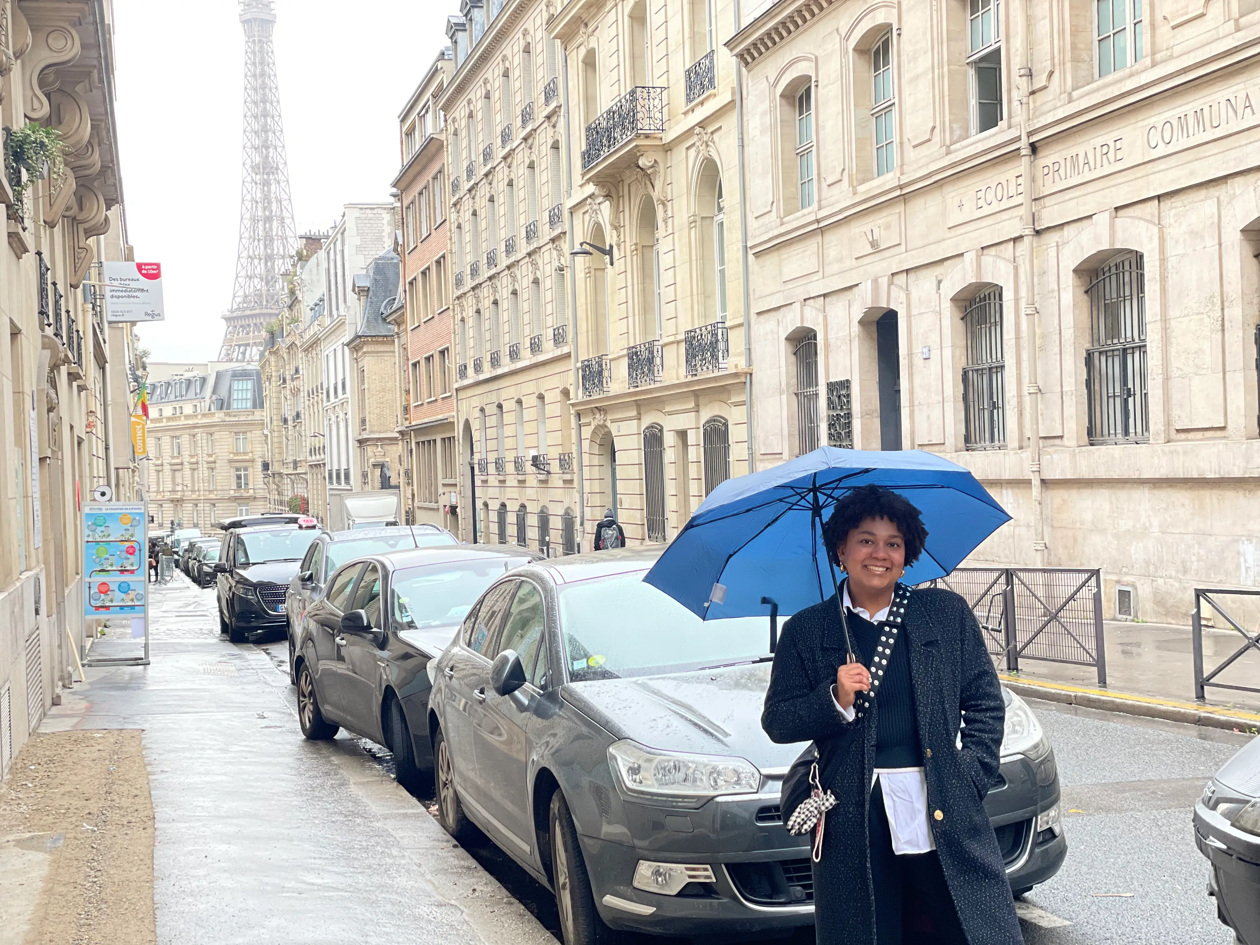 Woman smiling in PAris under umbrella
