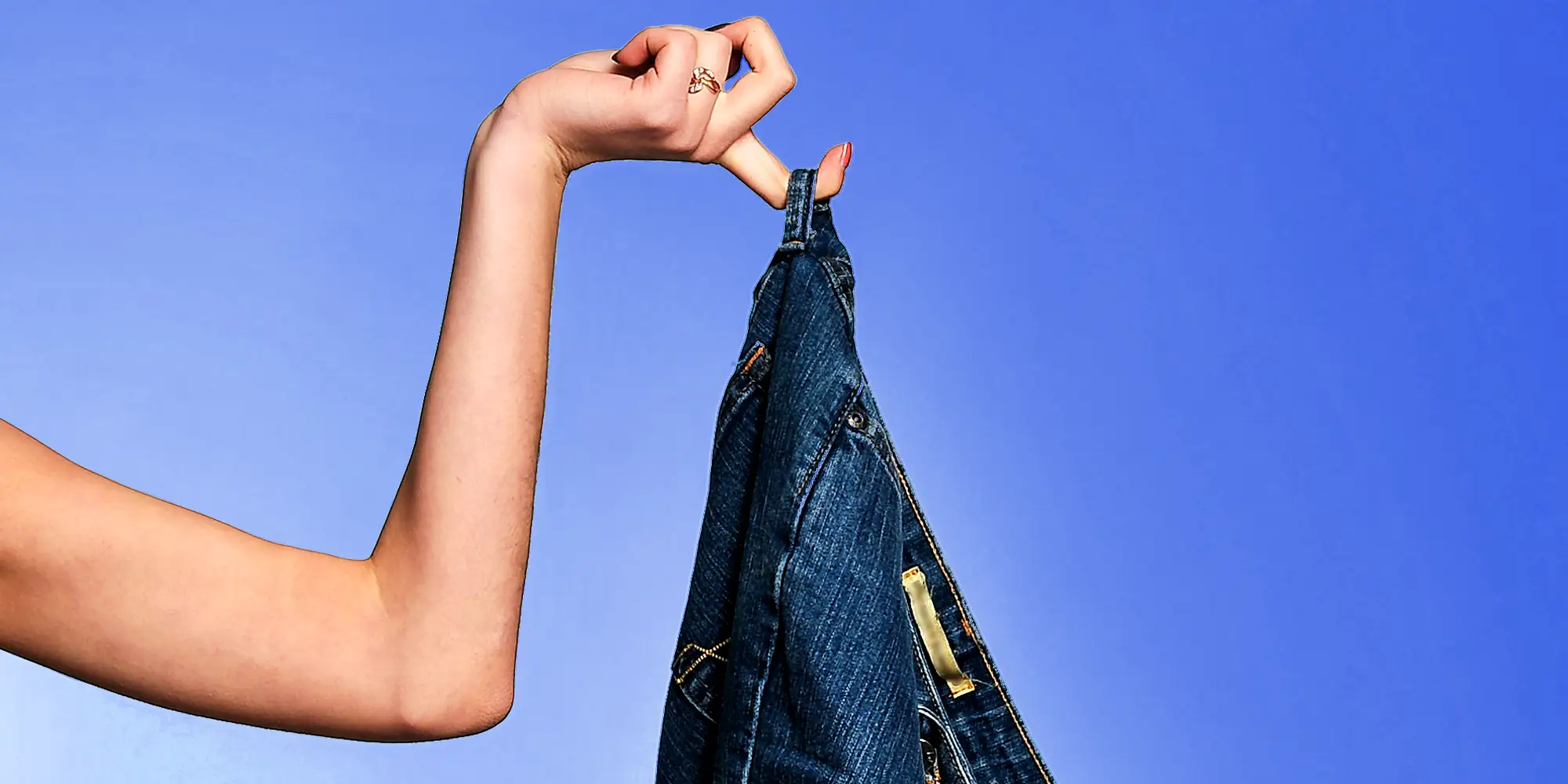 Hand holding a pair a jeans.