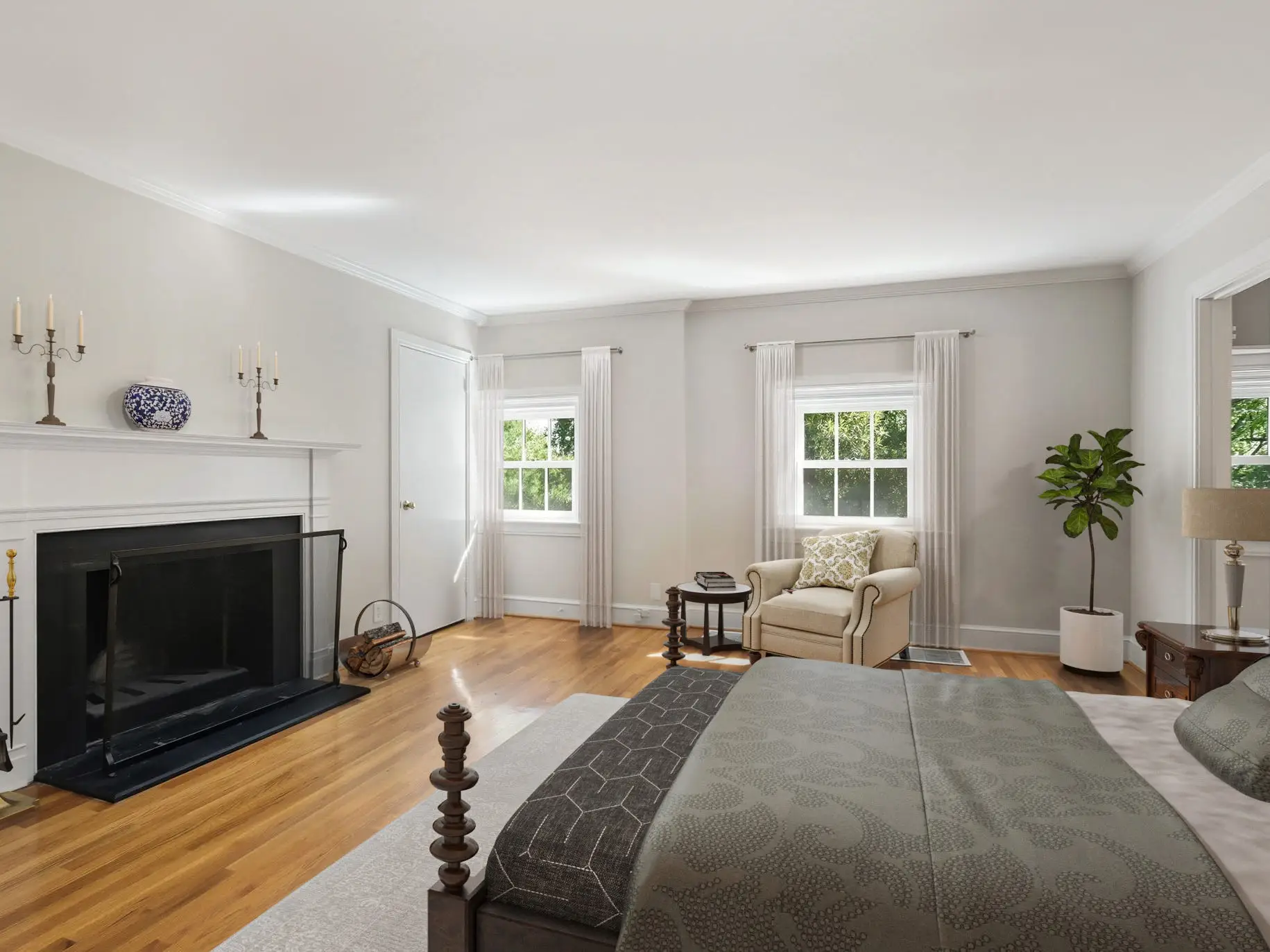 A large bed next to a fireplace.