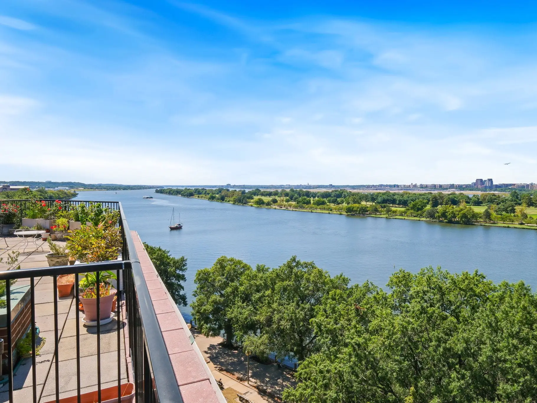 A balcony view overlooking a river.