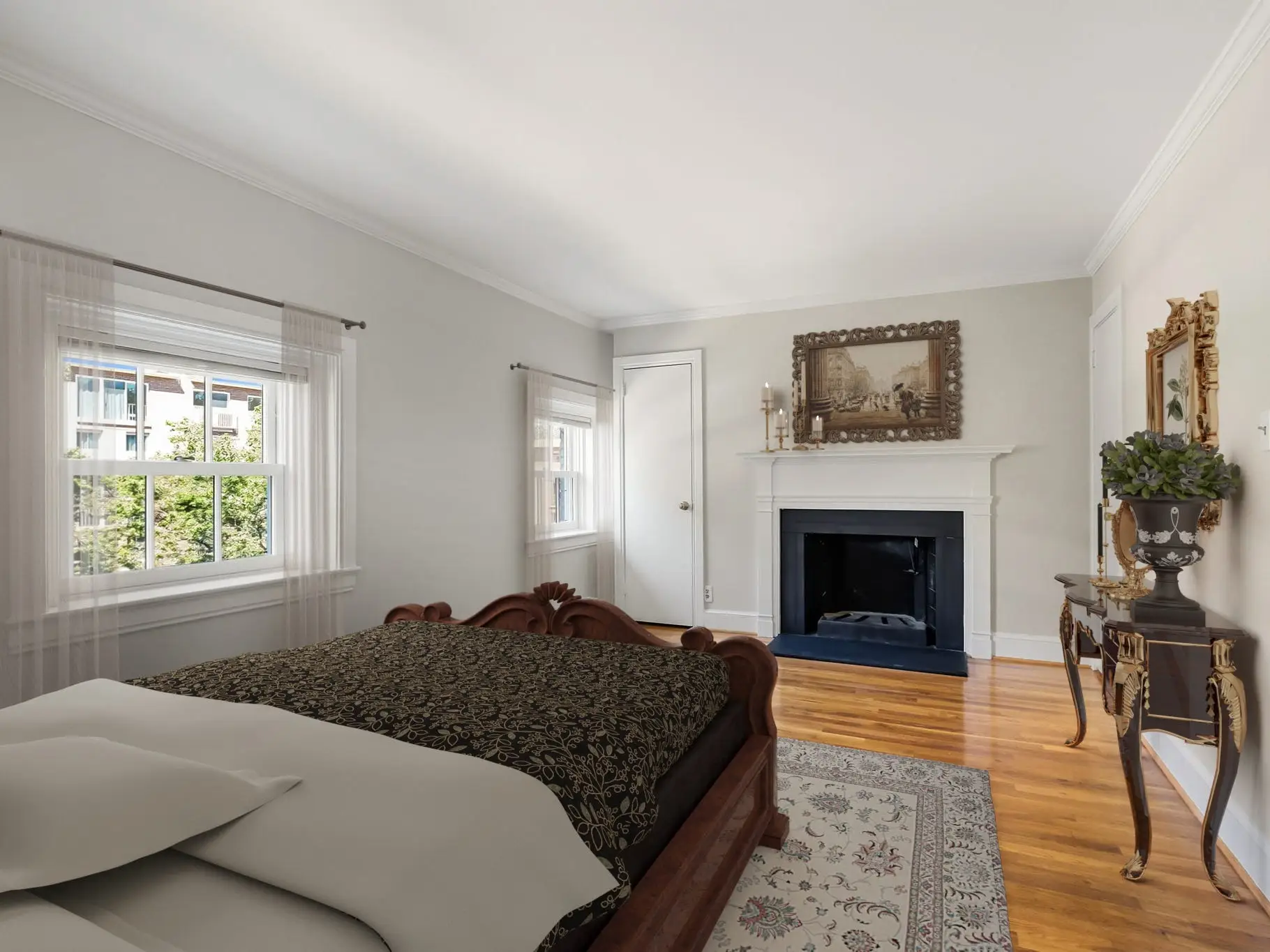 A bed in front of a fireplace.