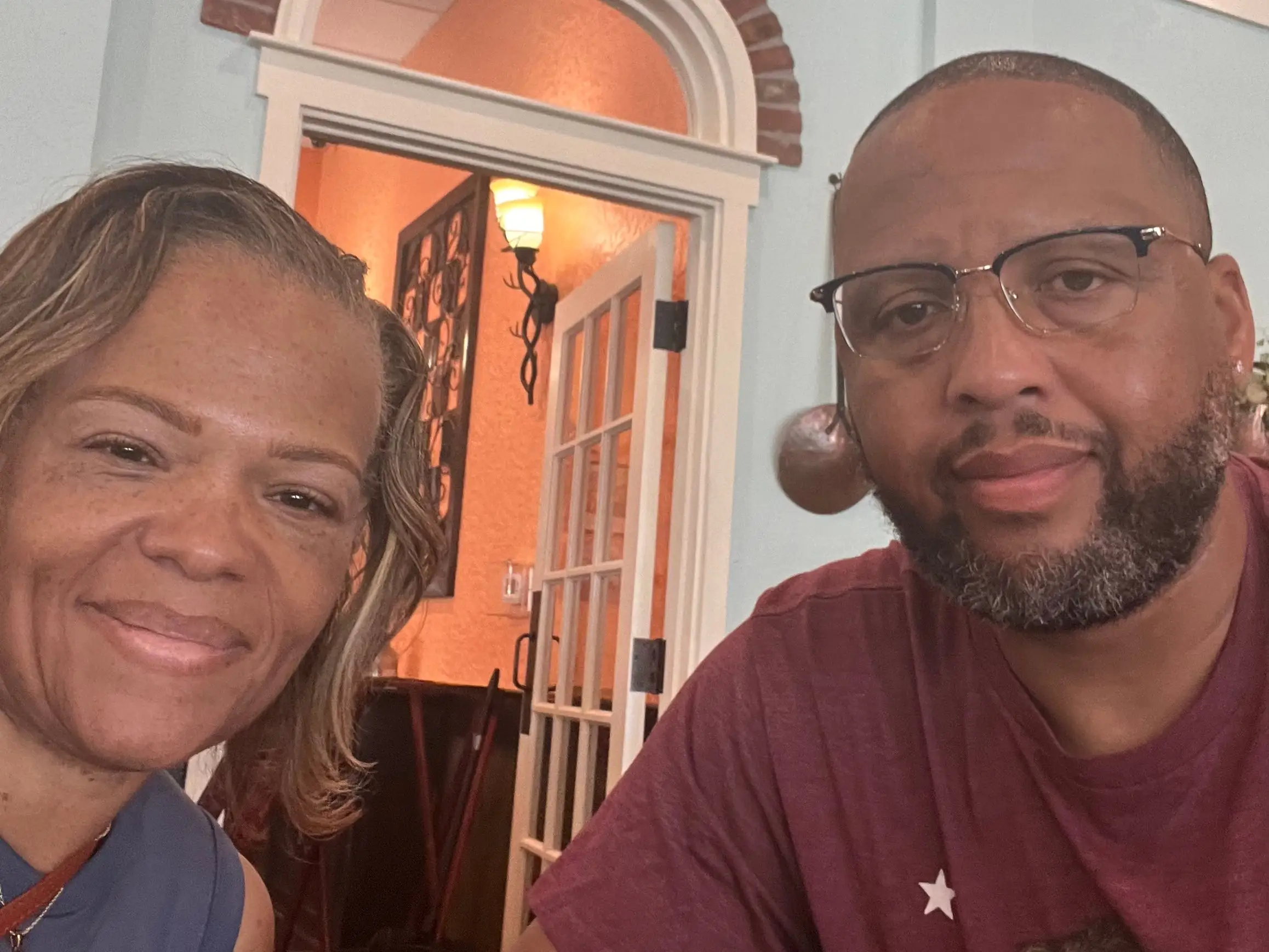 A man and a woman in front of a doorway