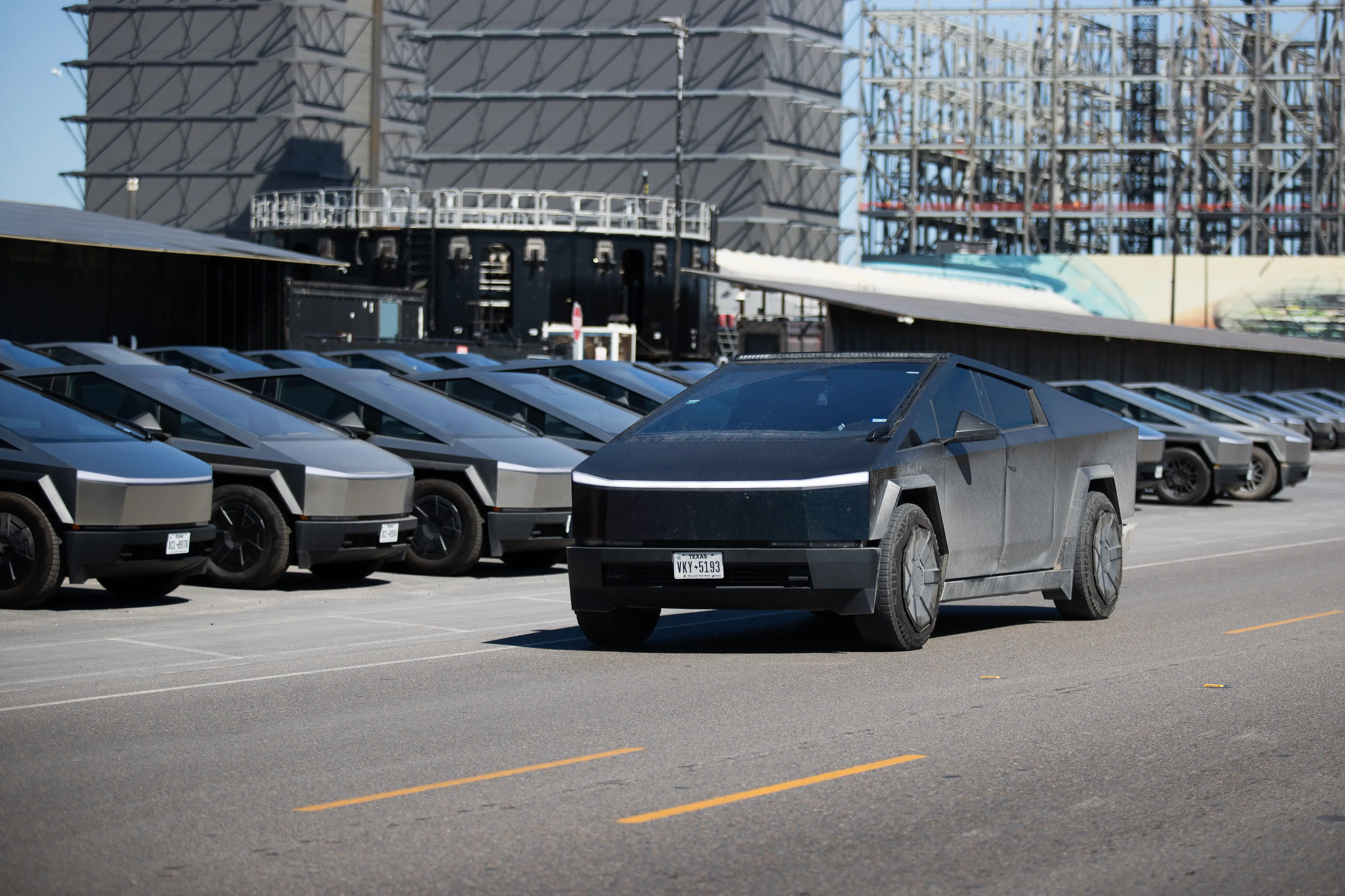 A fleet of Tesla Cybertrucks sits outside the Starbase Build Site at SpaceX's South Texas testing facility on February 6, 2026.