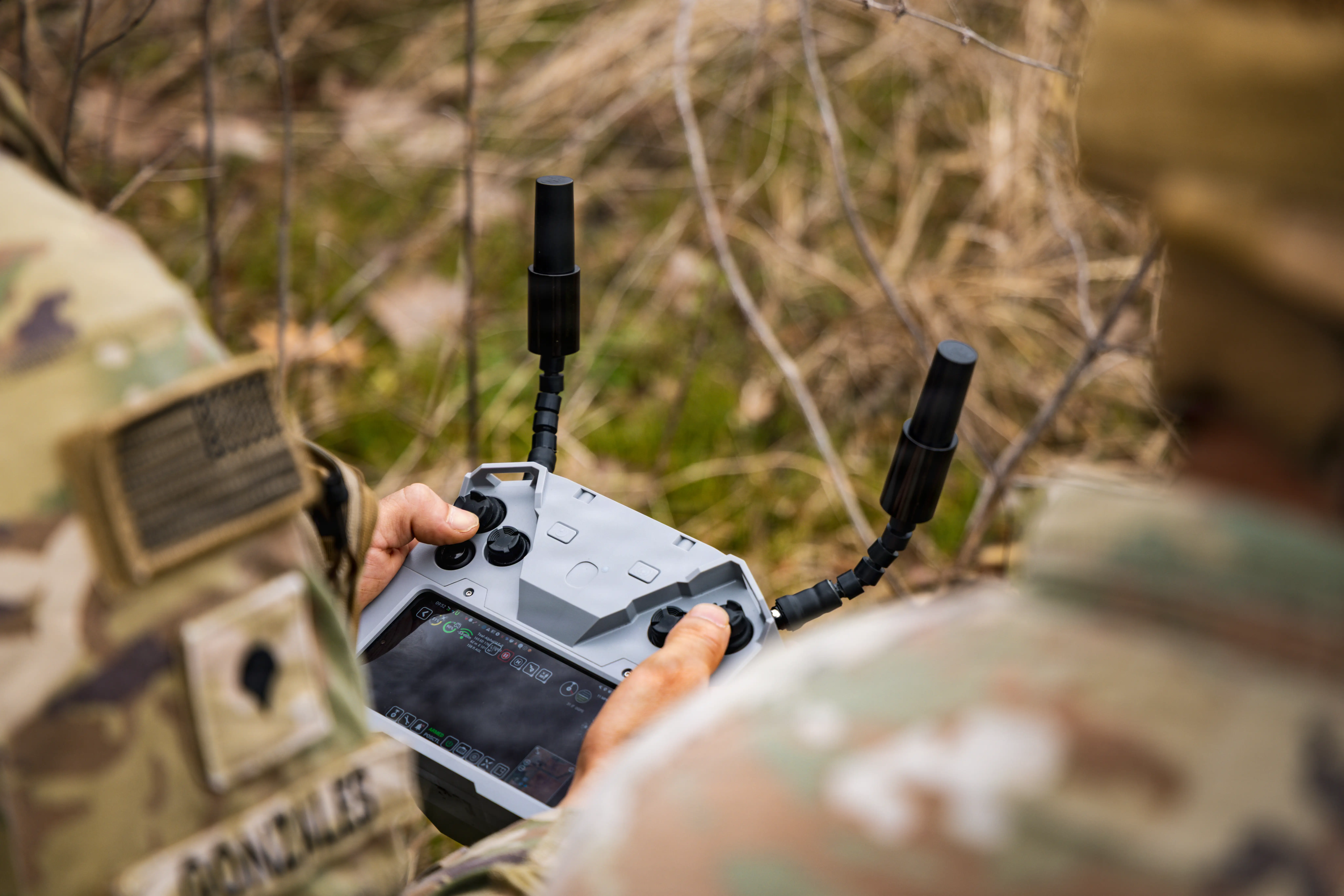 A soldier holds a drone controller.