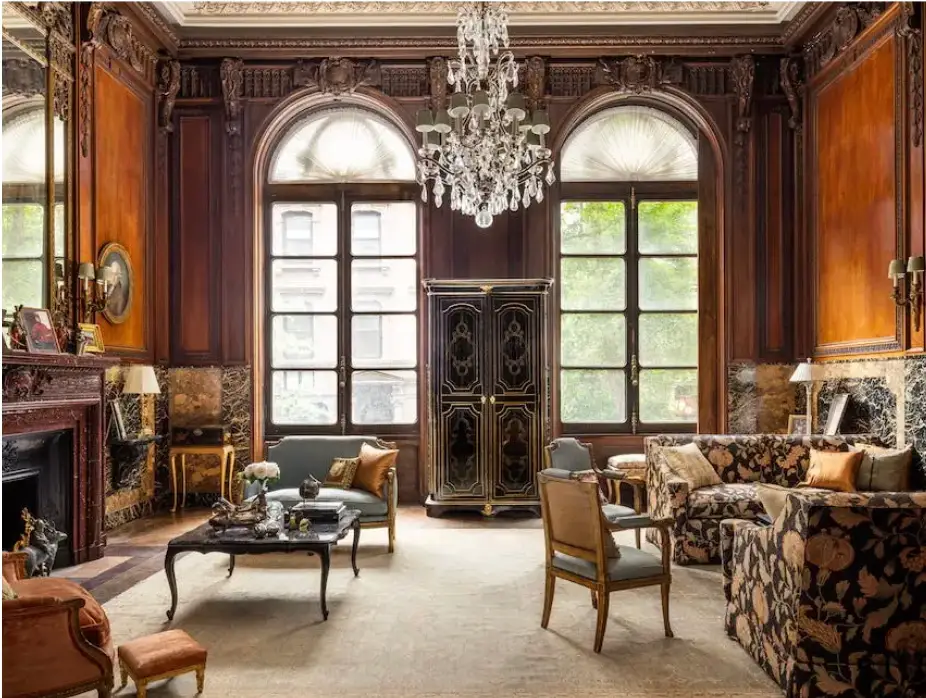 Another view of the Cassini mansion library shows light from East 63rd street streaming in through a pair of tall, arched windows.