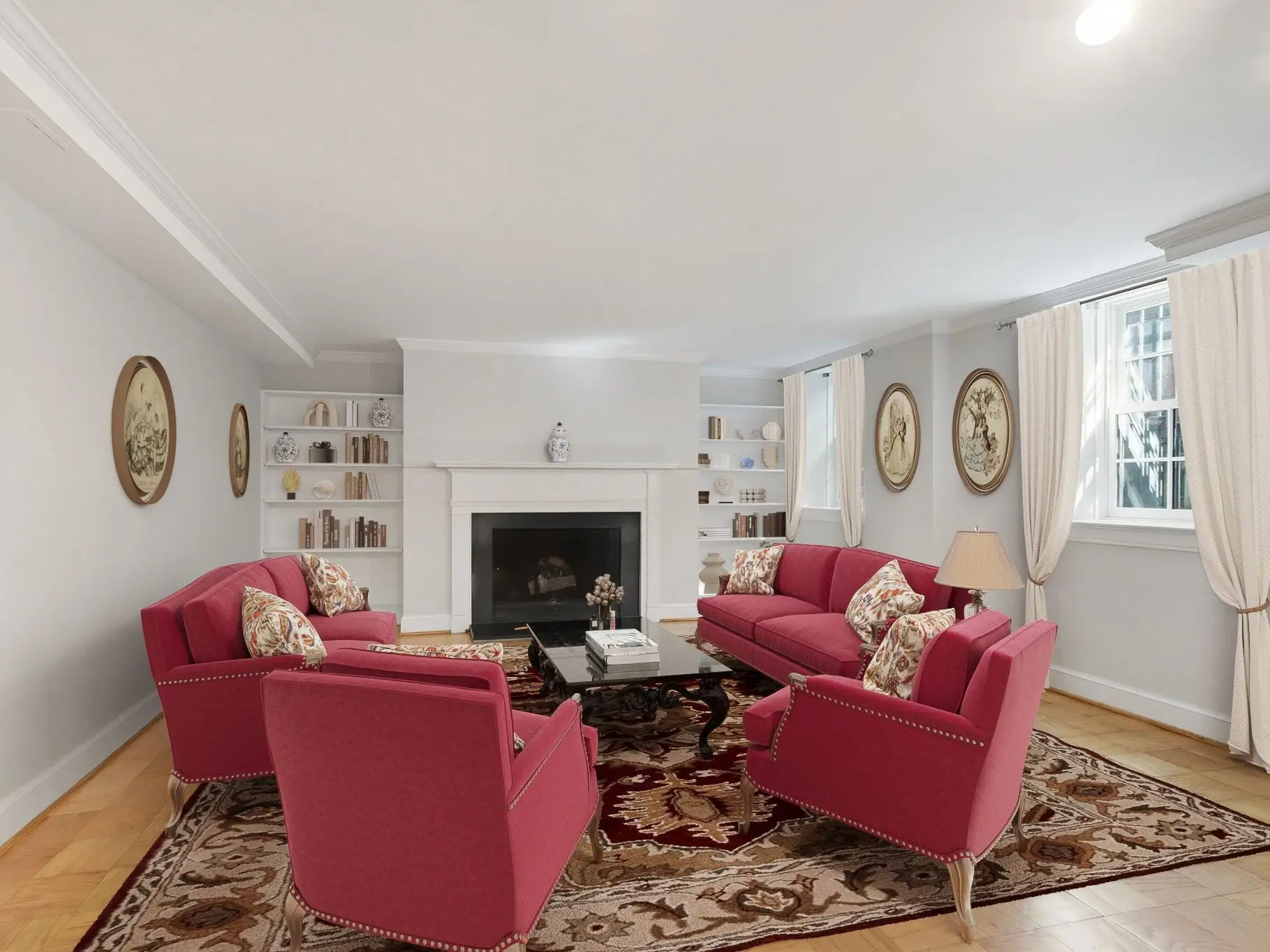 Two chairs next to two couches with wooden medallions on the walls.