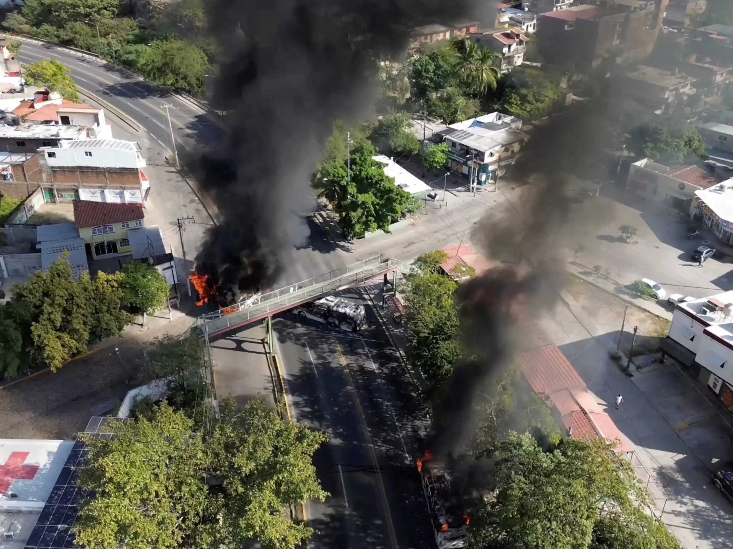 Smoke billows from burning vehicles amid a wave of violence, with torched vehicles and gunmen blocking highways in more than half a dozen states, following a military operation in which a government source said Mexican drug lord Nemesio Oseguera, known as 