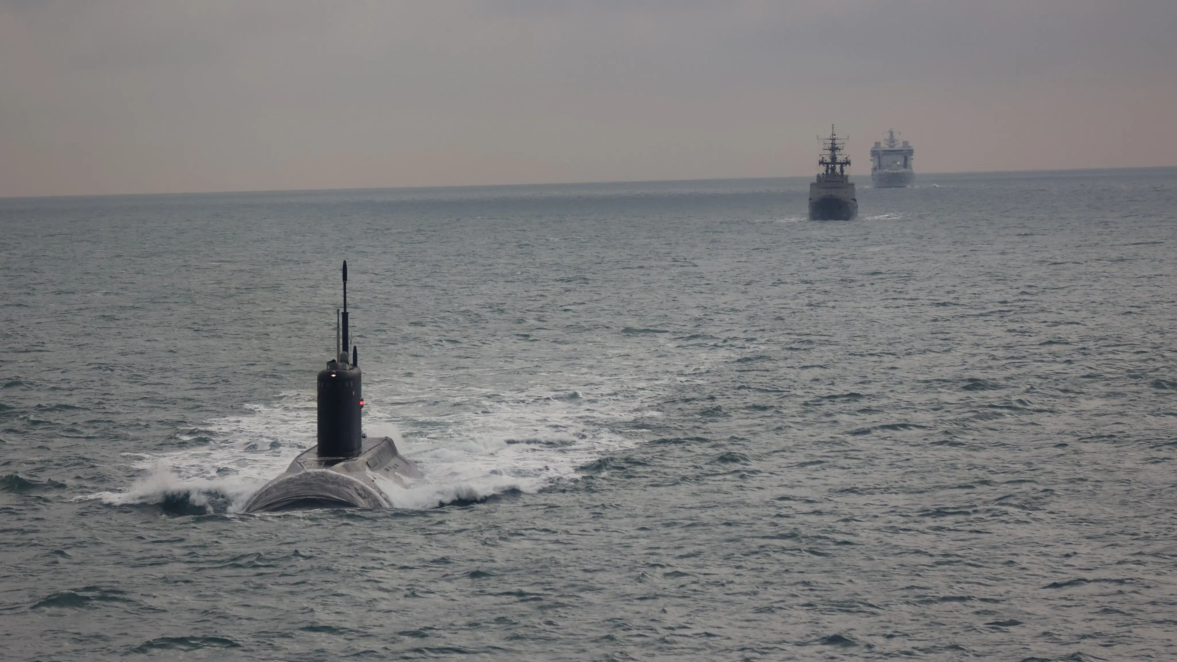 A Russian submarine is followed by British ships in the English Channel in 2025.