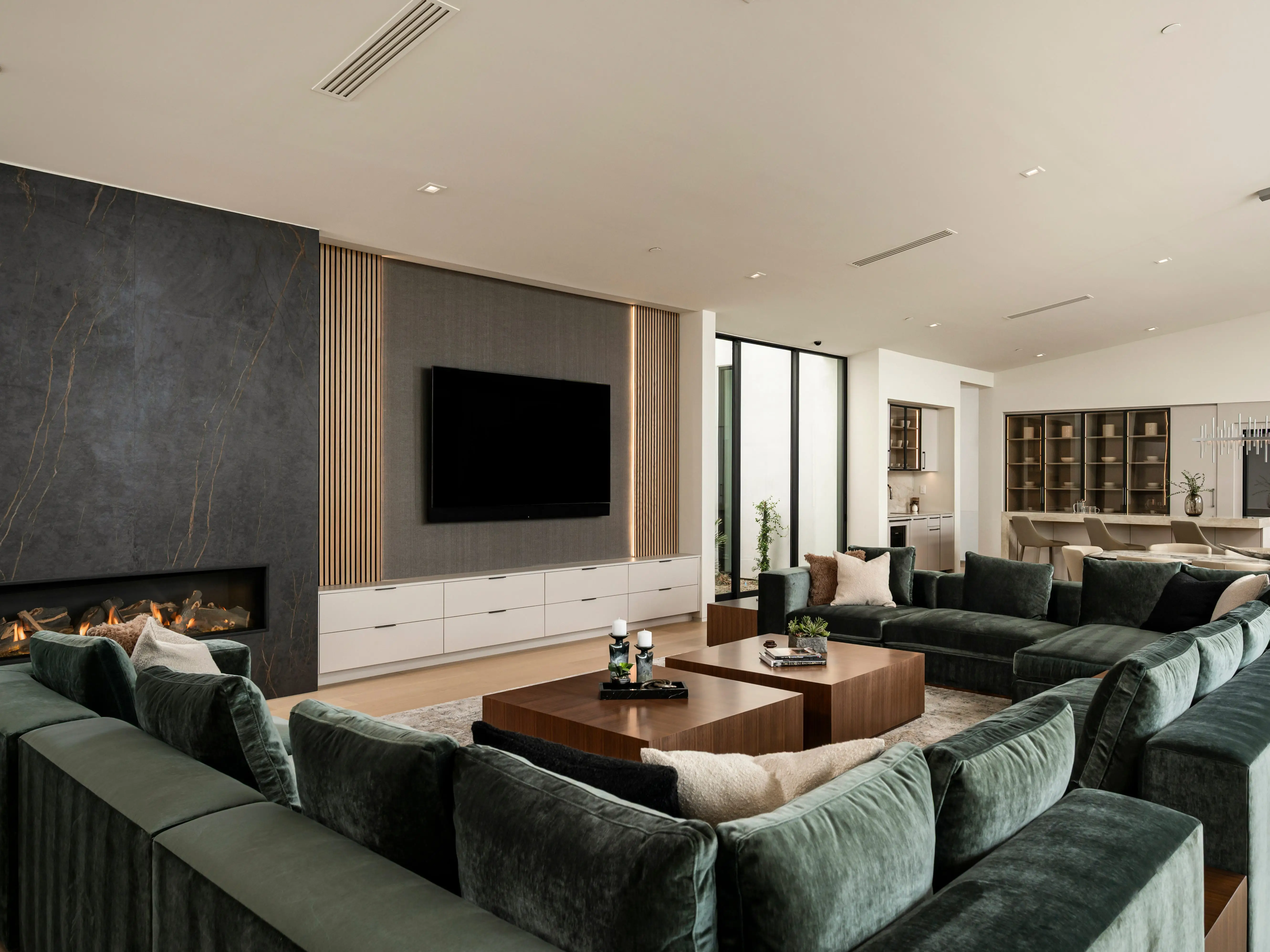 Couches in front of a TV screen.