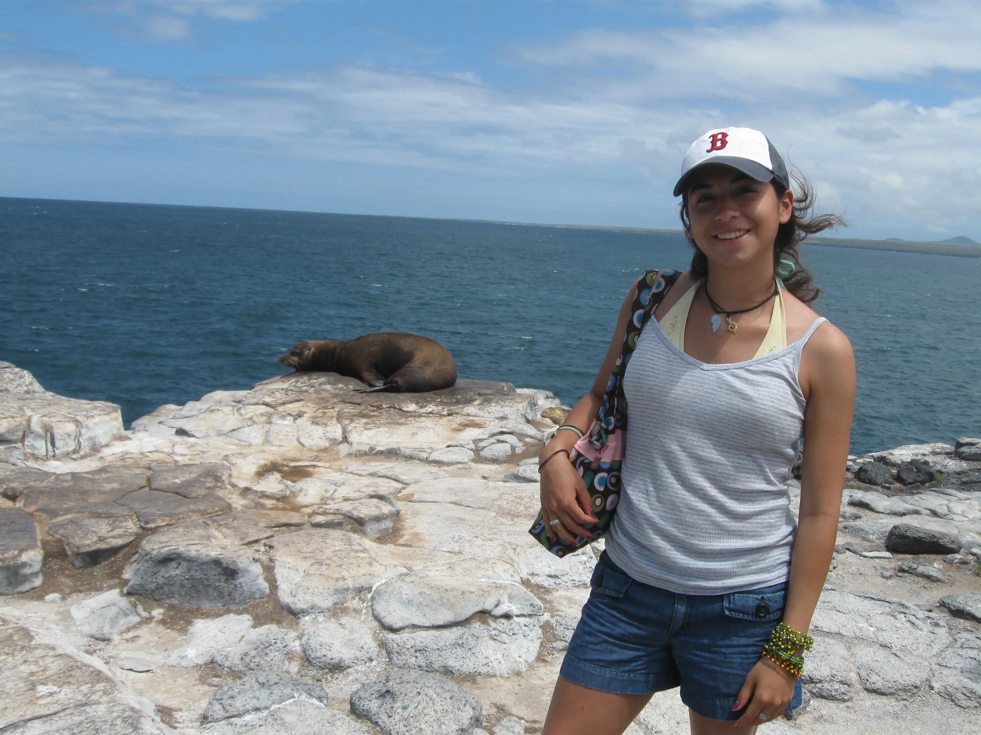 Ashleigh N. DeLuca on The Galápagos Islands during her gap year with a seal behind her