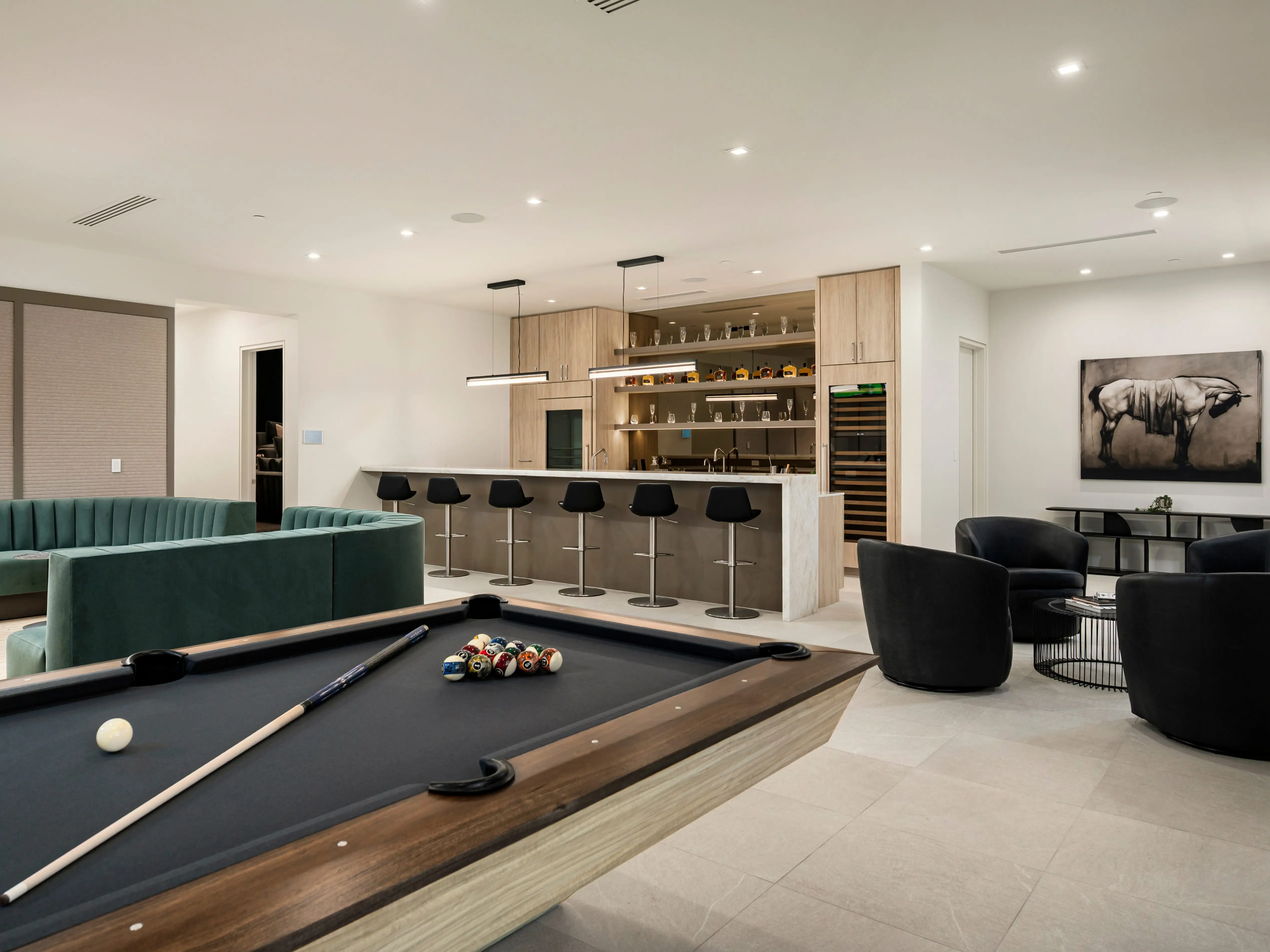 A pool table, chairs, and a wet bar.