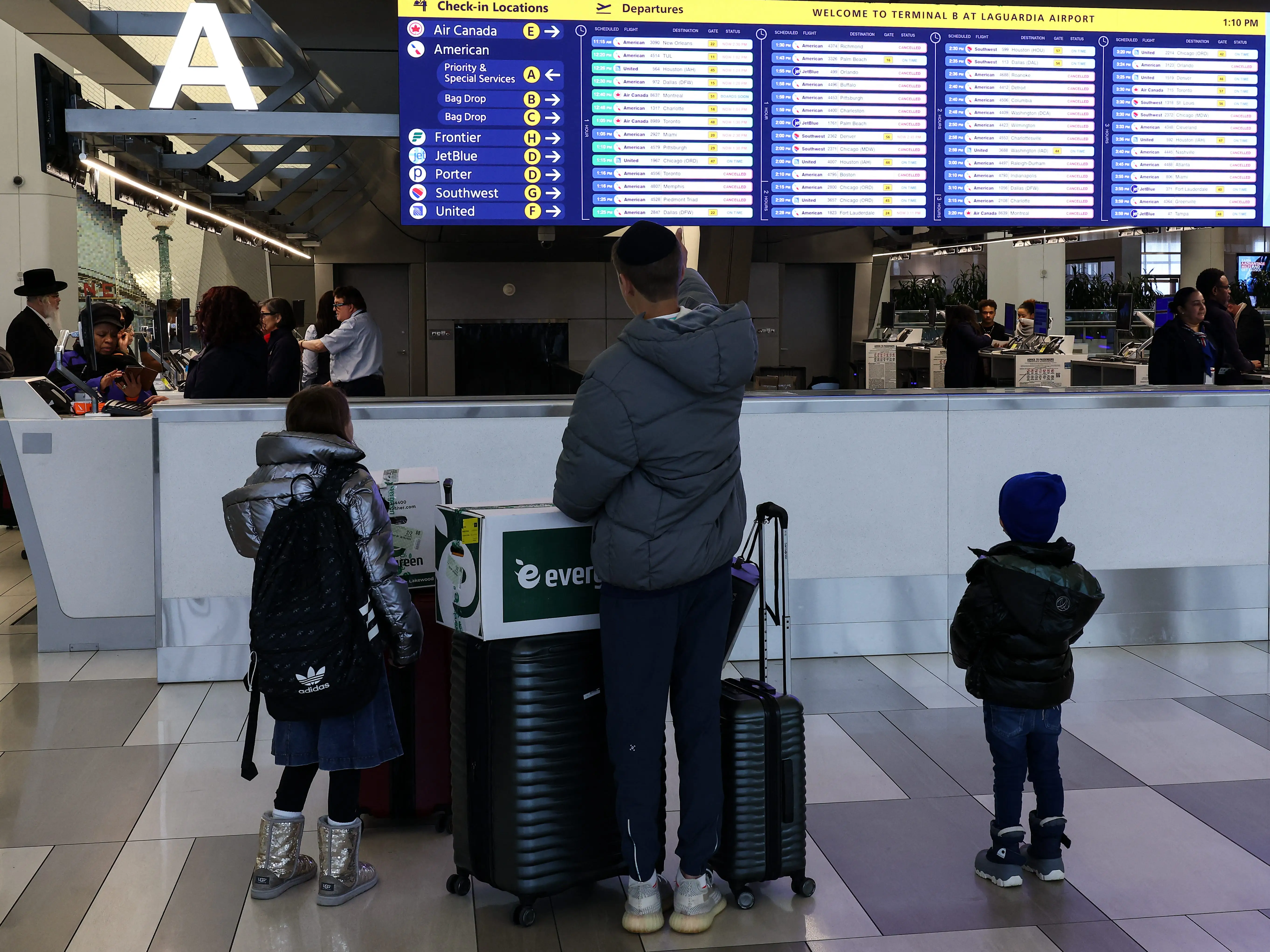 Flight board at LaGuardia airport shows cancellations.