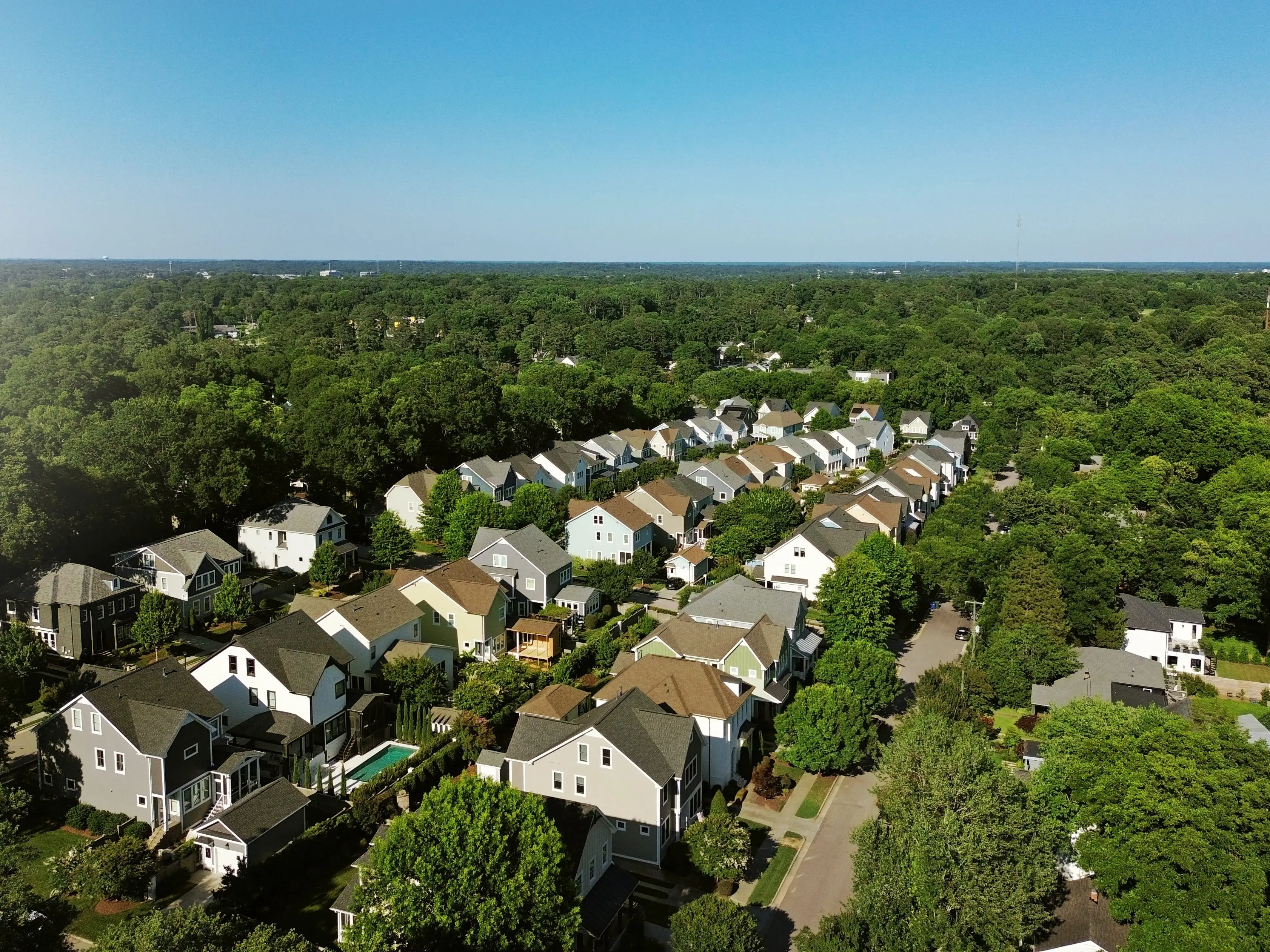 Aerial view of new homes in a housing development with tree lined streets in Raleigh North Carolina