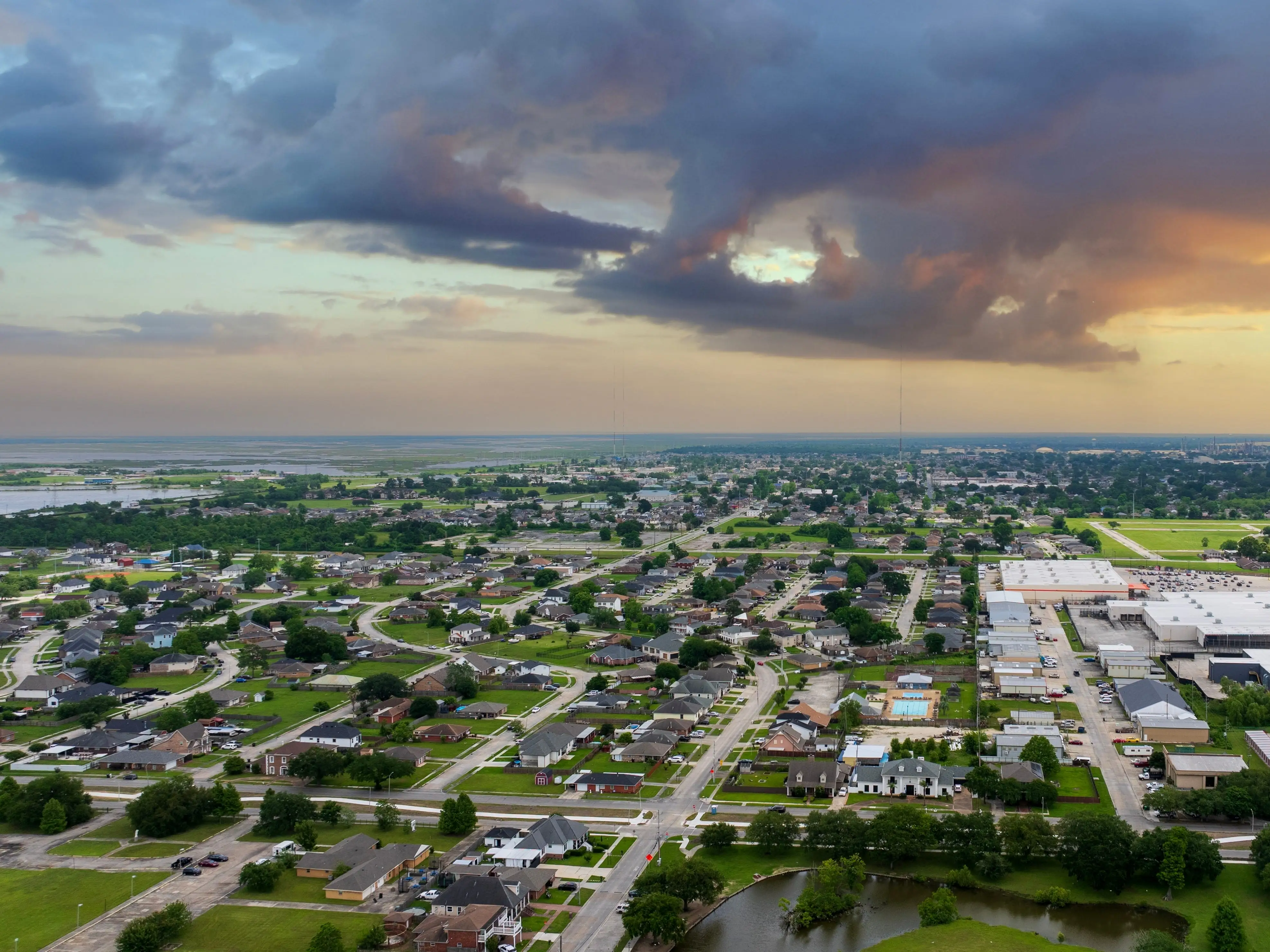 aerial shot of homes and marshland with water and lush green trees in Chalmette Louisiana USA