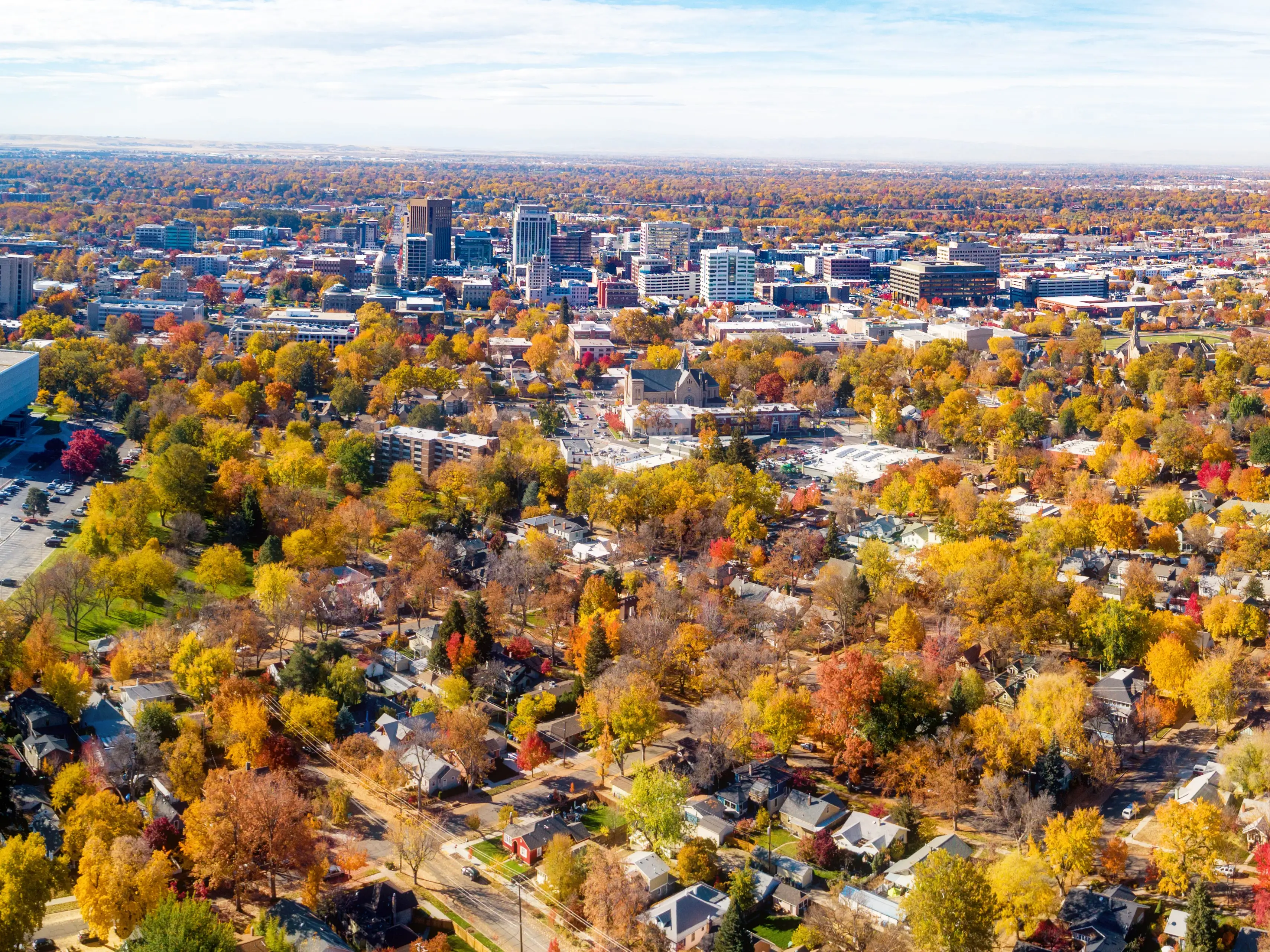 Panoramic of Boise City and residential aerial view of homes with fall colors