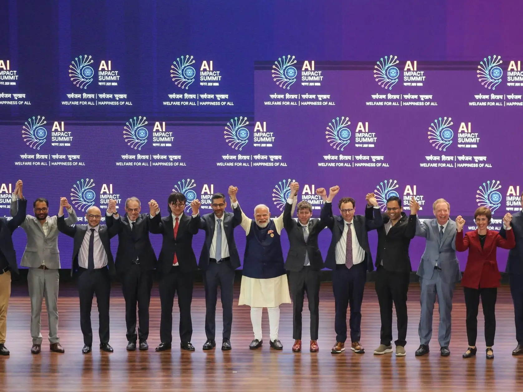 Tech leaders, including Dario Amodei and Sam Altman, at an AI summit in India