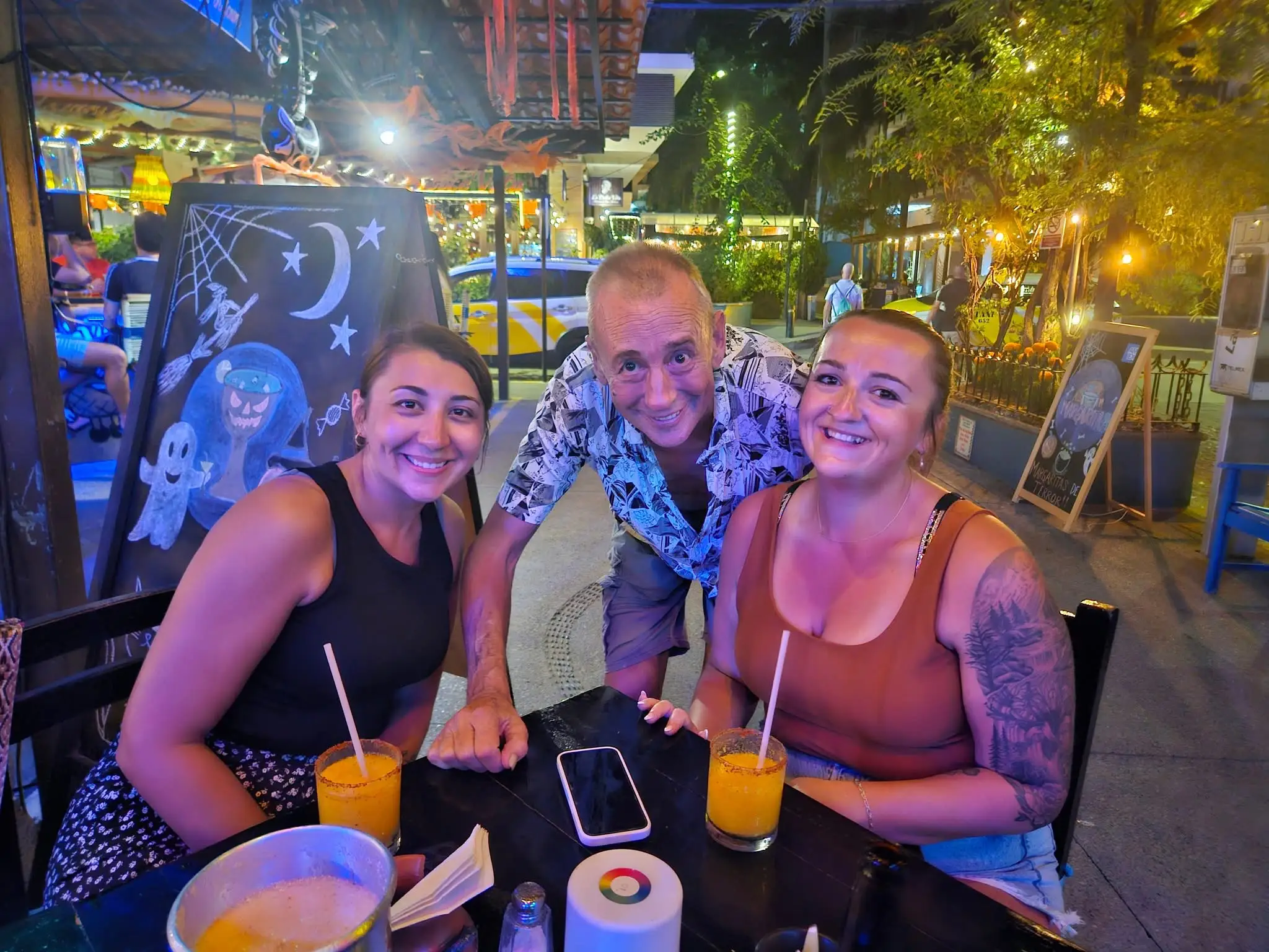 Doug Howell and his two daughters at a restaurant in Mexico.