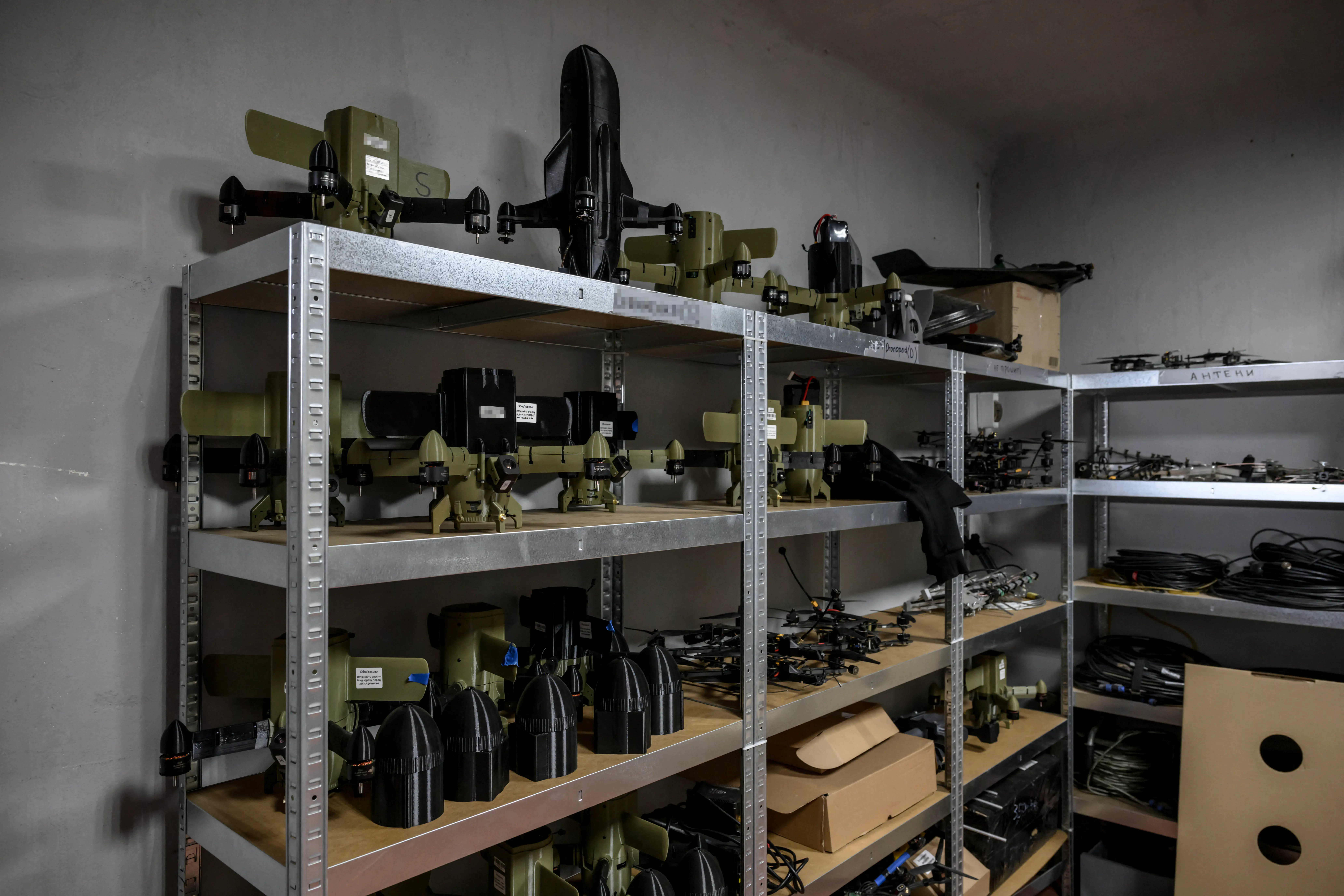 Ukrainian interceptor drones sit on a shelf.