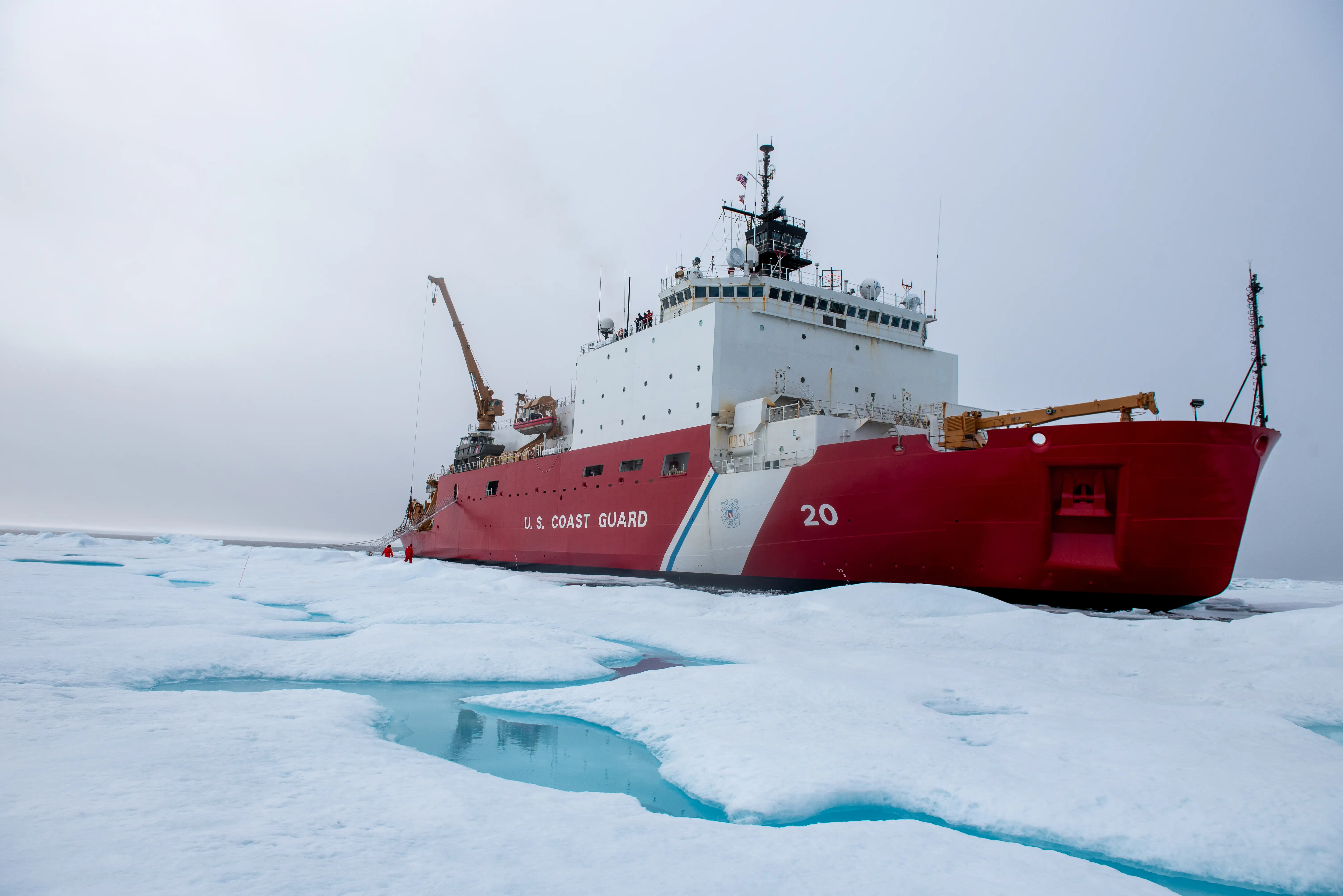 The icebreaker USCGC Healy keeps station while conducting crane operations alongside a multi-year ice floe for a science evolution in the Beaufort Sea, August 9, 2023.