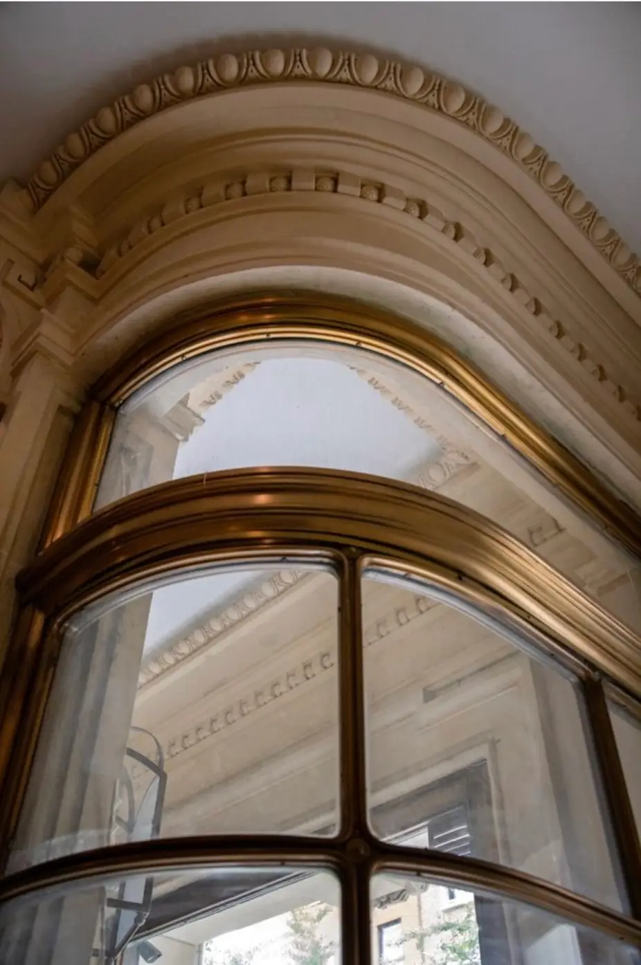 A closeup of the Cassini mansion vestibule shows its unusual, turn-of-the-century curve of marble, brass and glass.