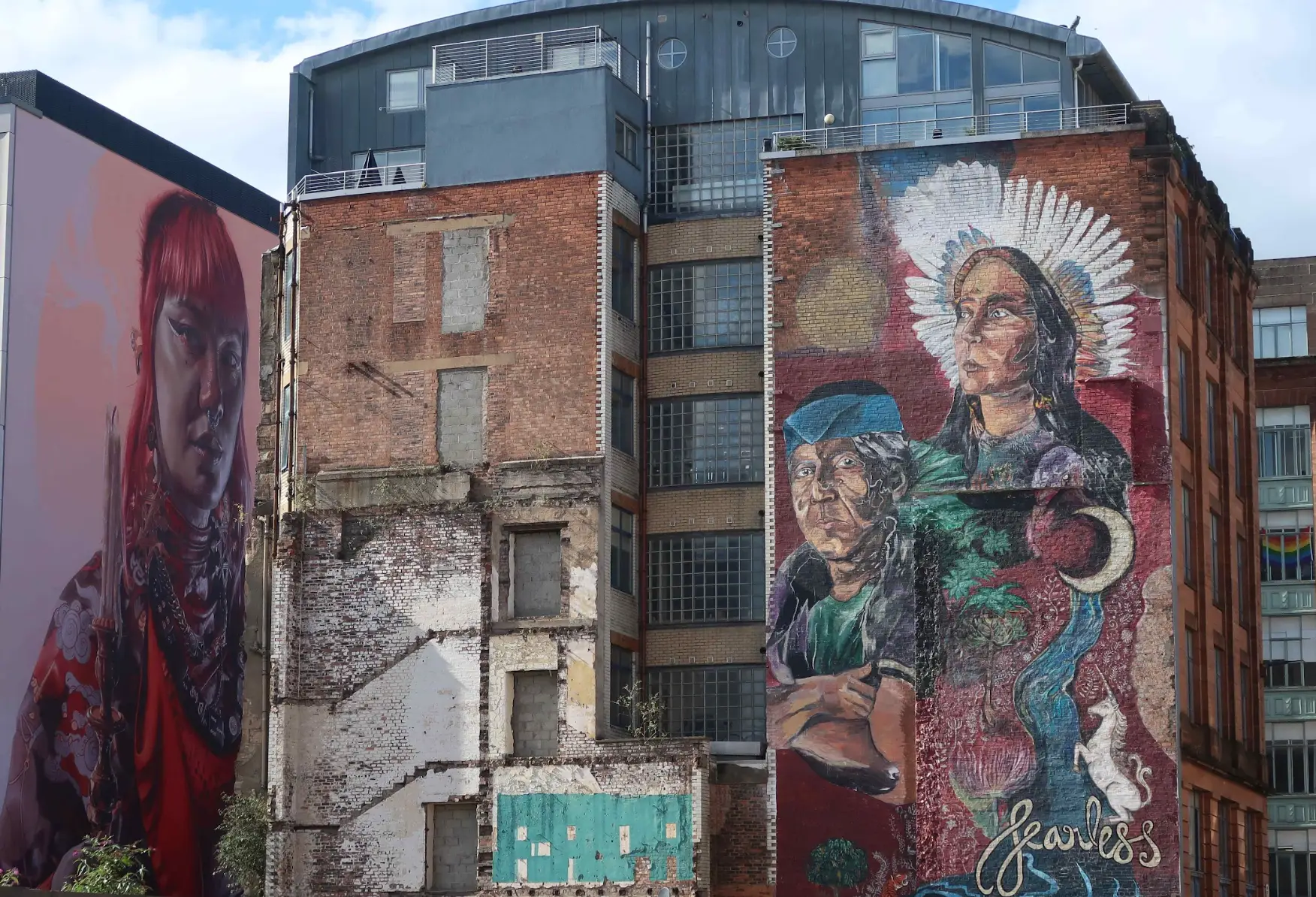 Two murals on tall buildings in Glasgow, Scotland.