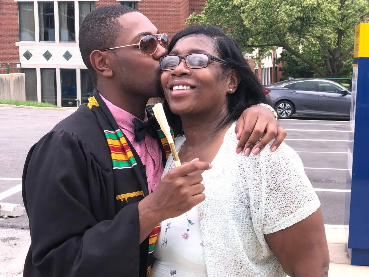 Ty Cole kissing his mother on graduation day