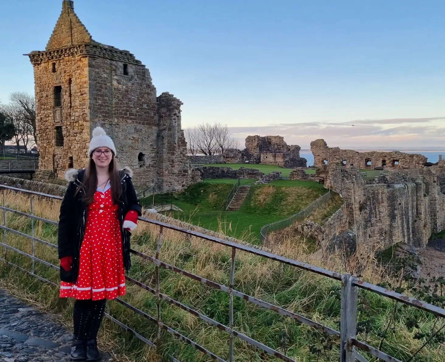 The writer posing in front of St Andrews Castle in Scotland.