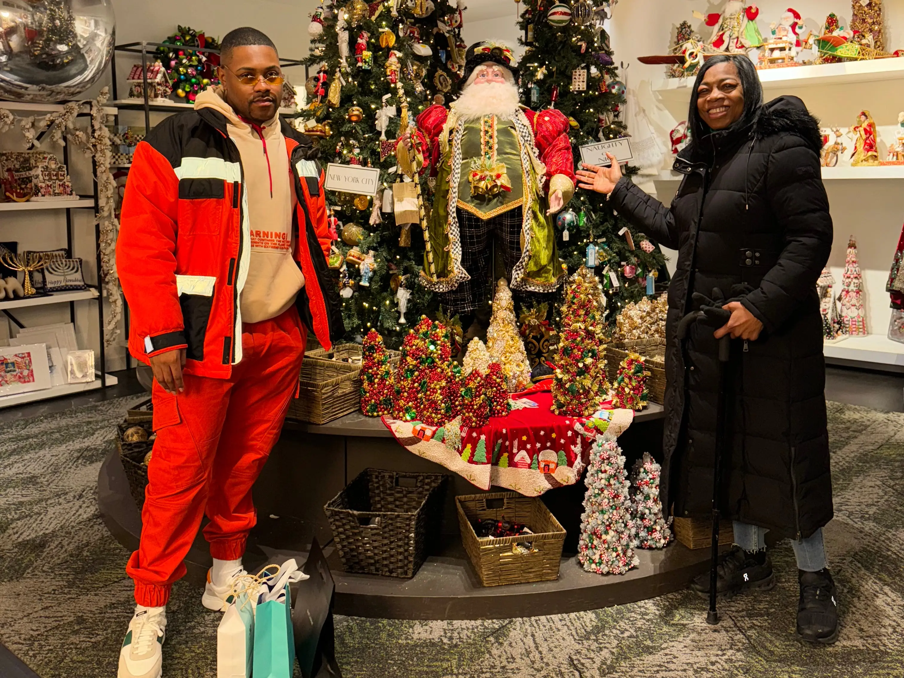 Ty Cole and his mother in front of a christmas tree display