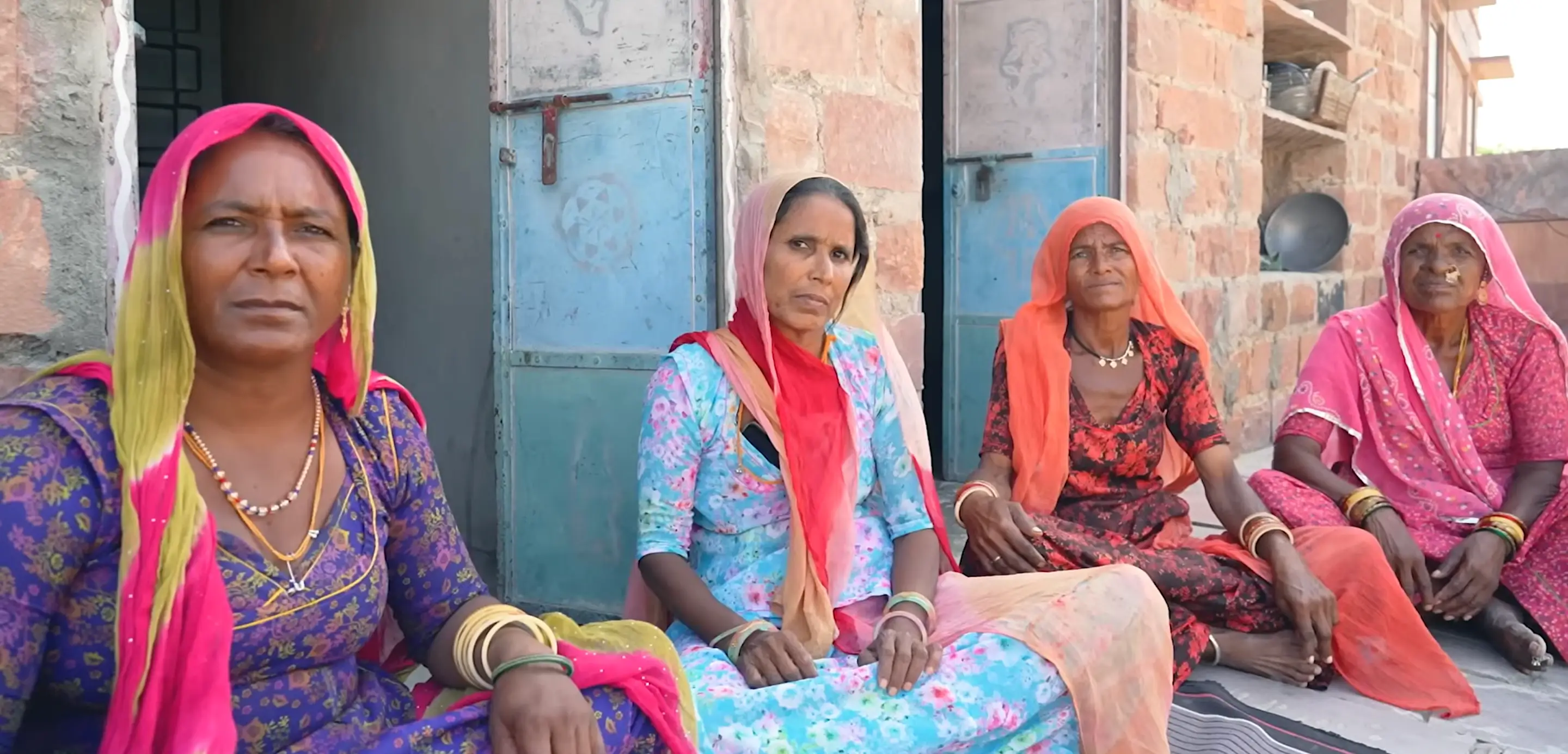 Four women in colorful Indian attire.