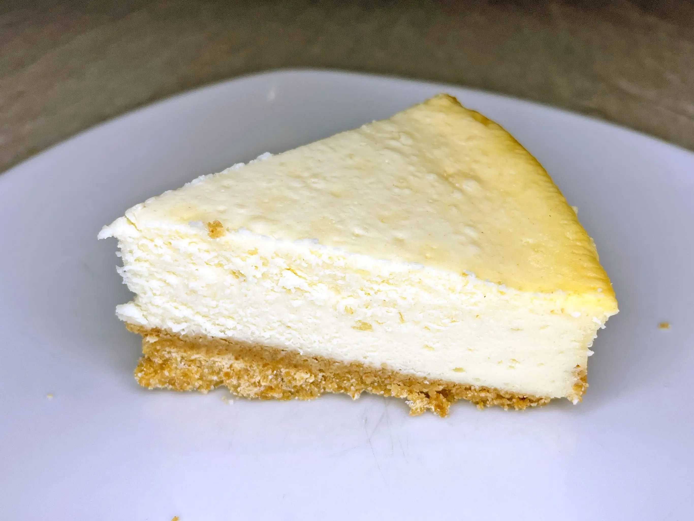 A slice of cheesecake on a white plate.
