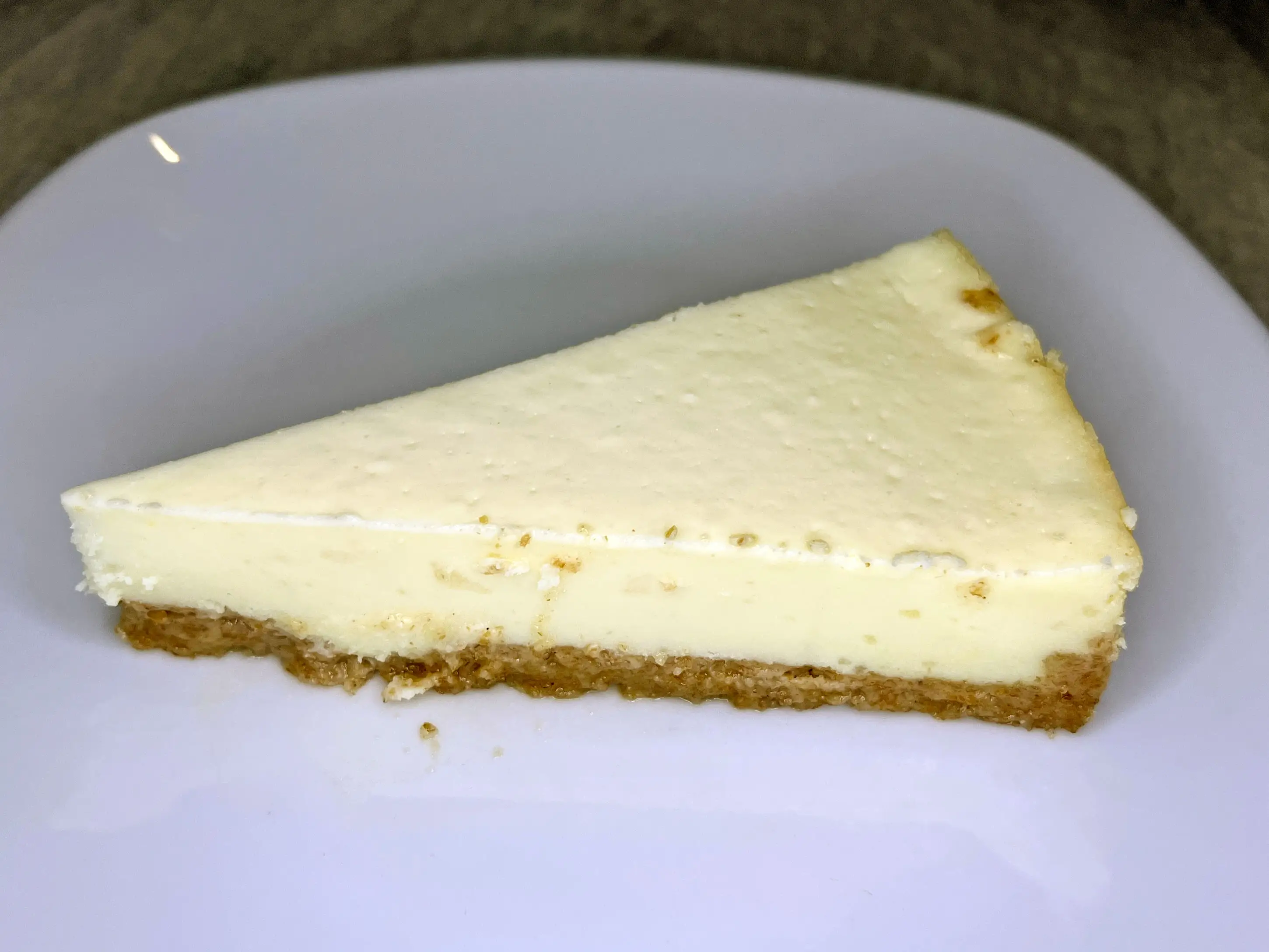 A slice of cheesecake on a white plate.