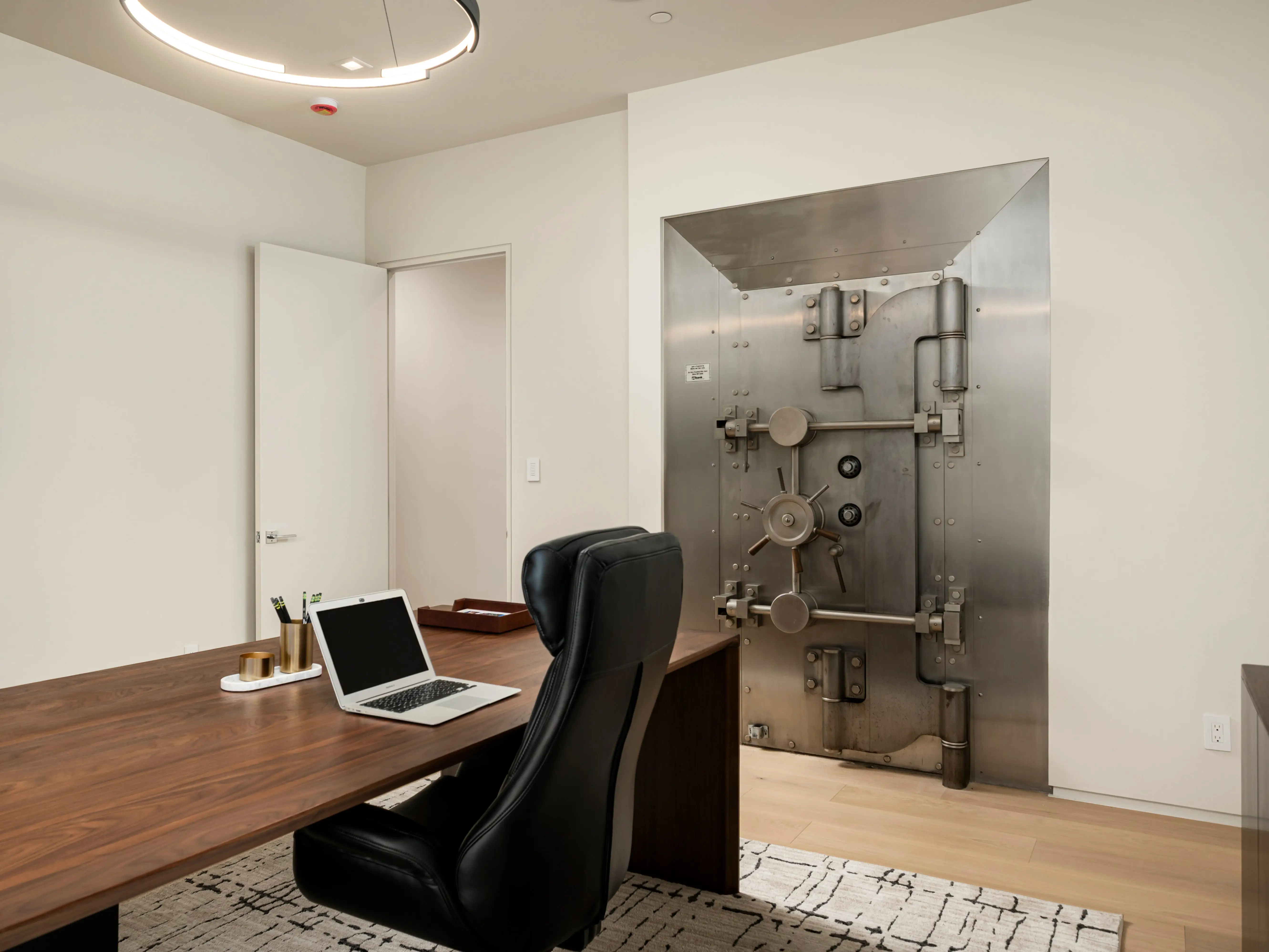 A chair in front of a bank vault.