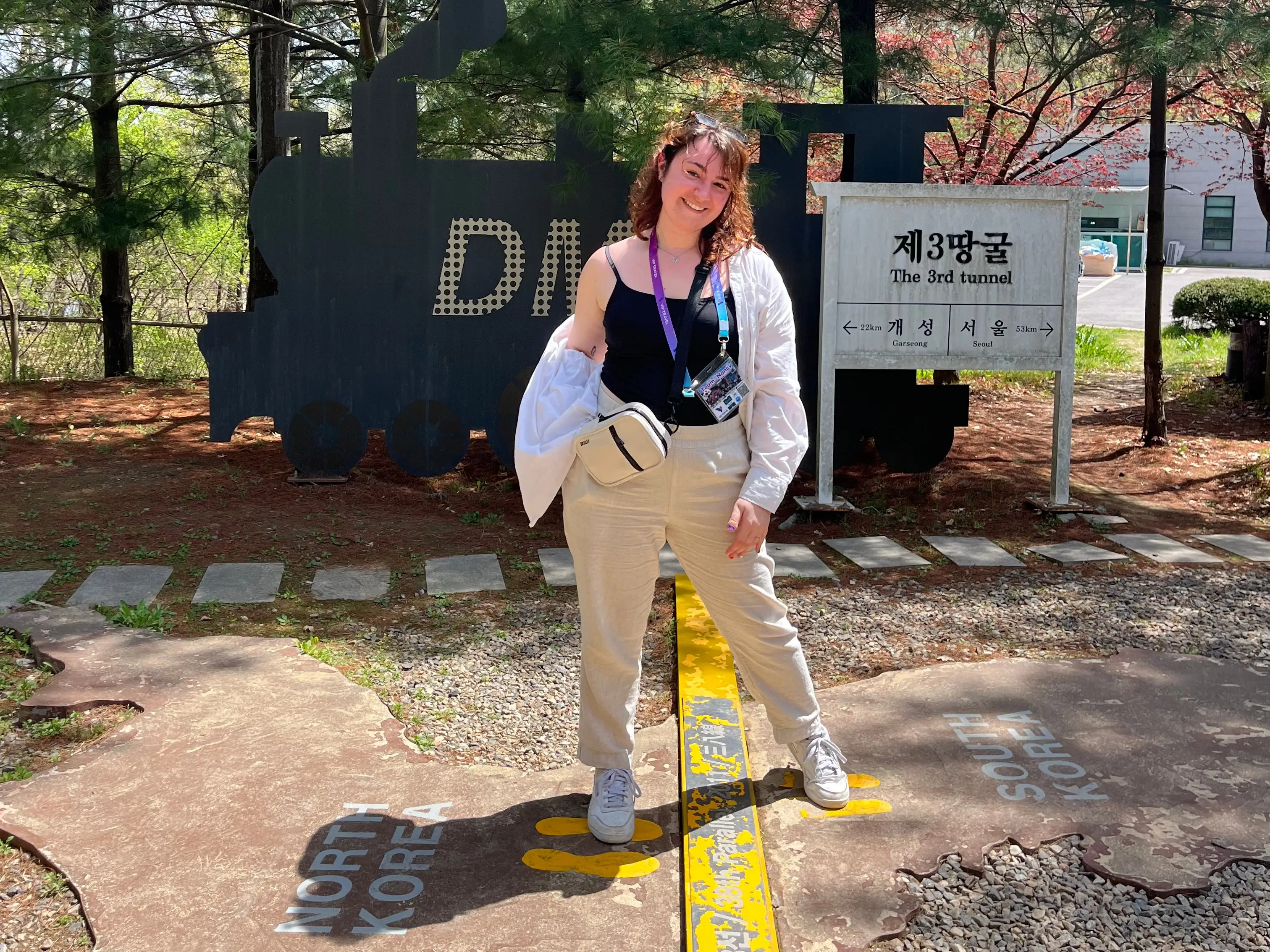 A woman standing on the DMZ between South and North Korea.