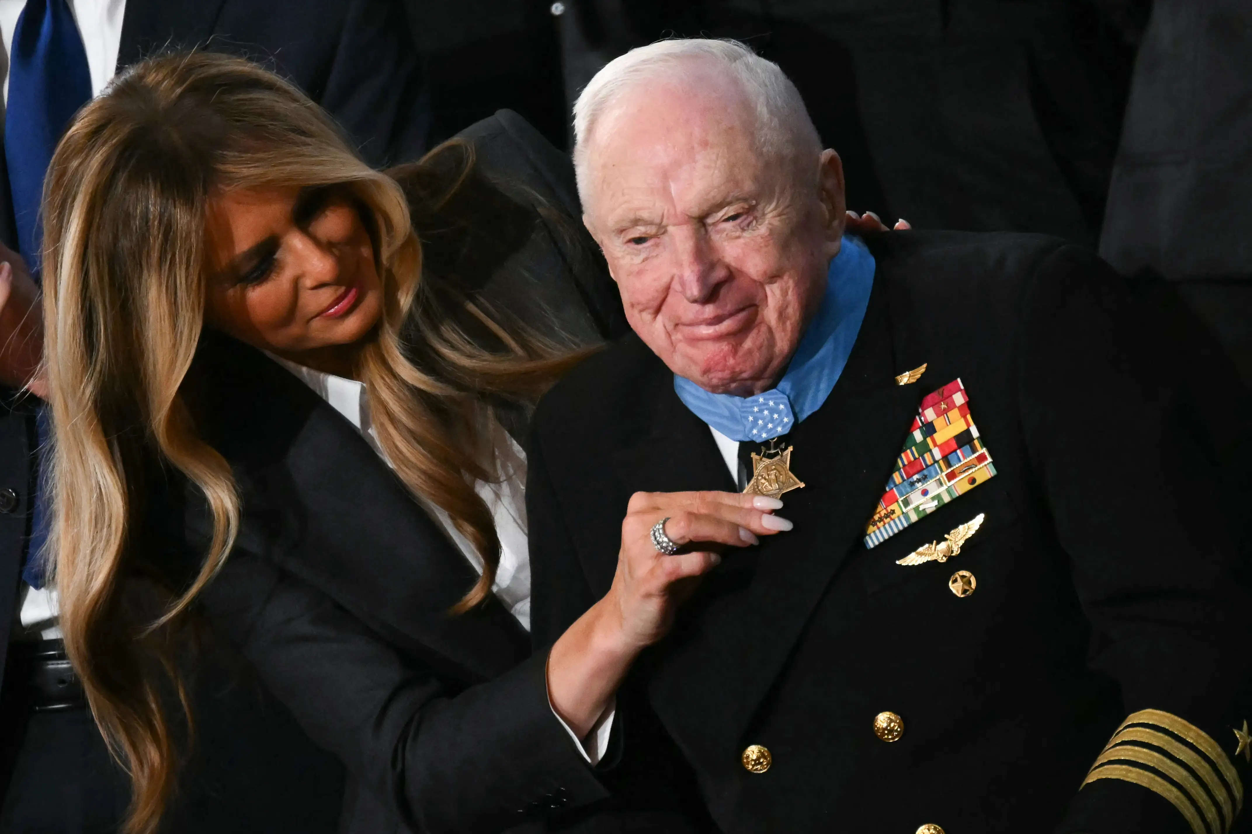 US First Lady Melania Trump presents US veteran Captain E. Royce Williams with the Medal of Honor
