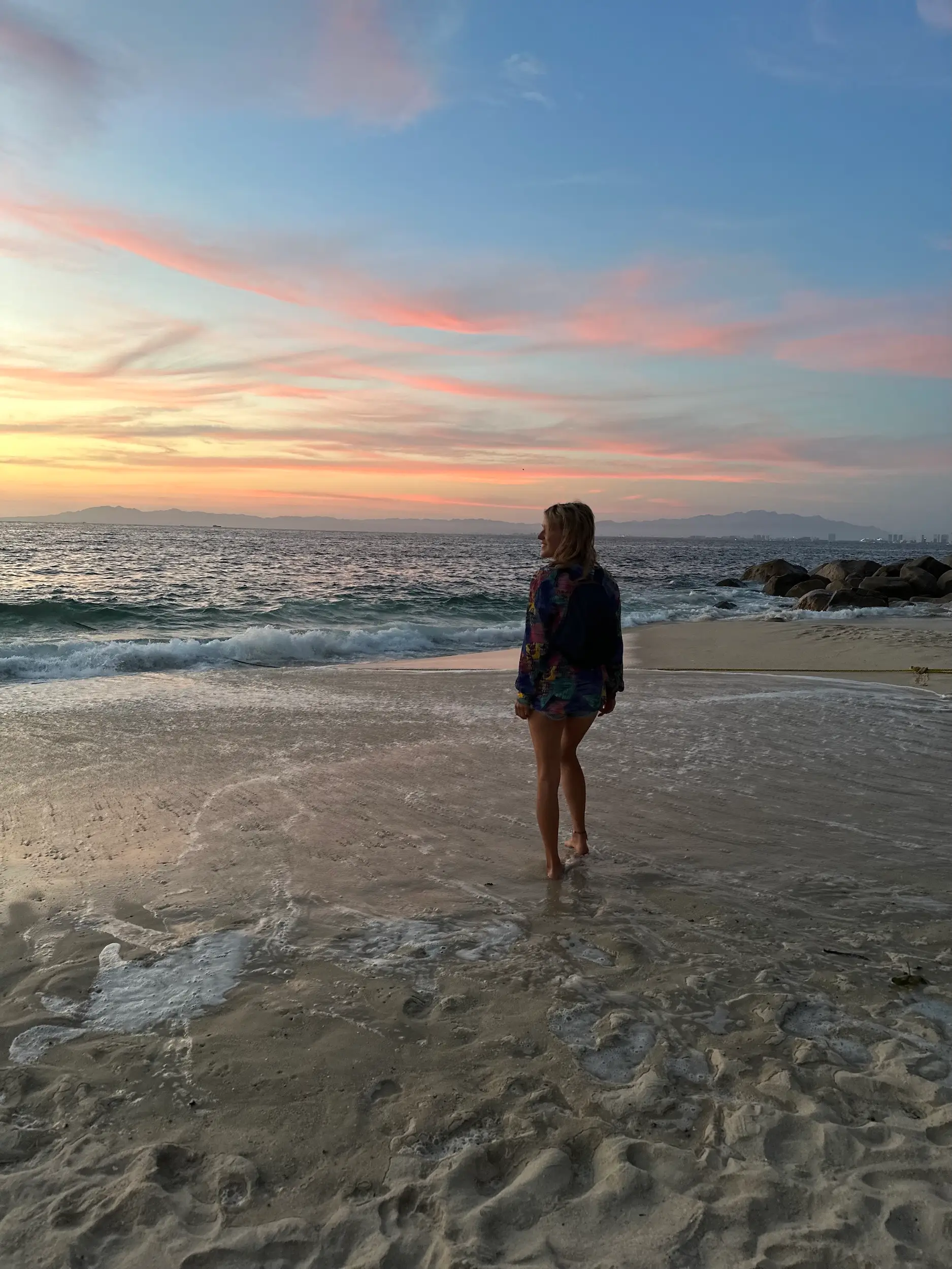 A woman watching the sunset on the beach in Mexico.
