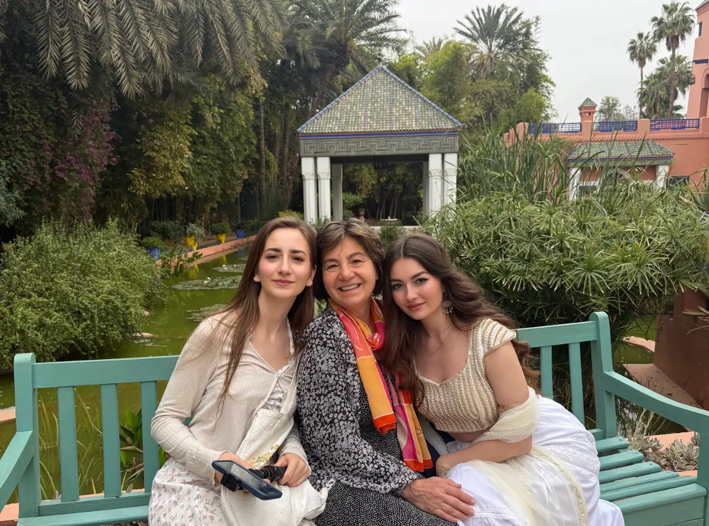 The writer sitting on a bench with her mom and sister.