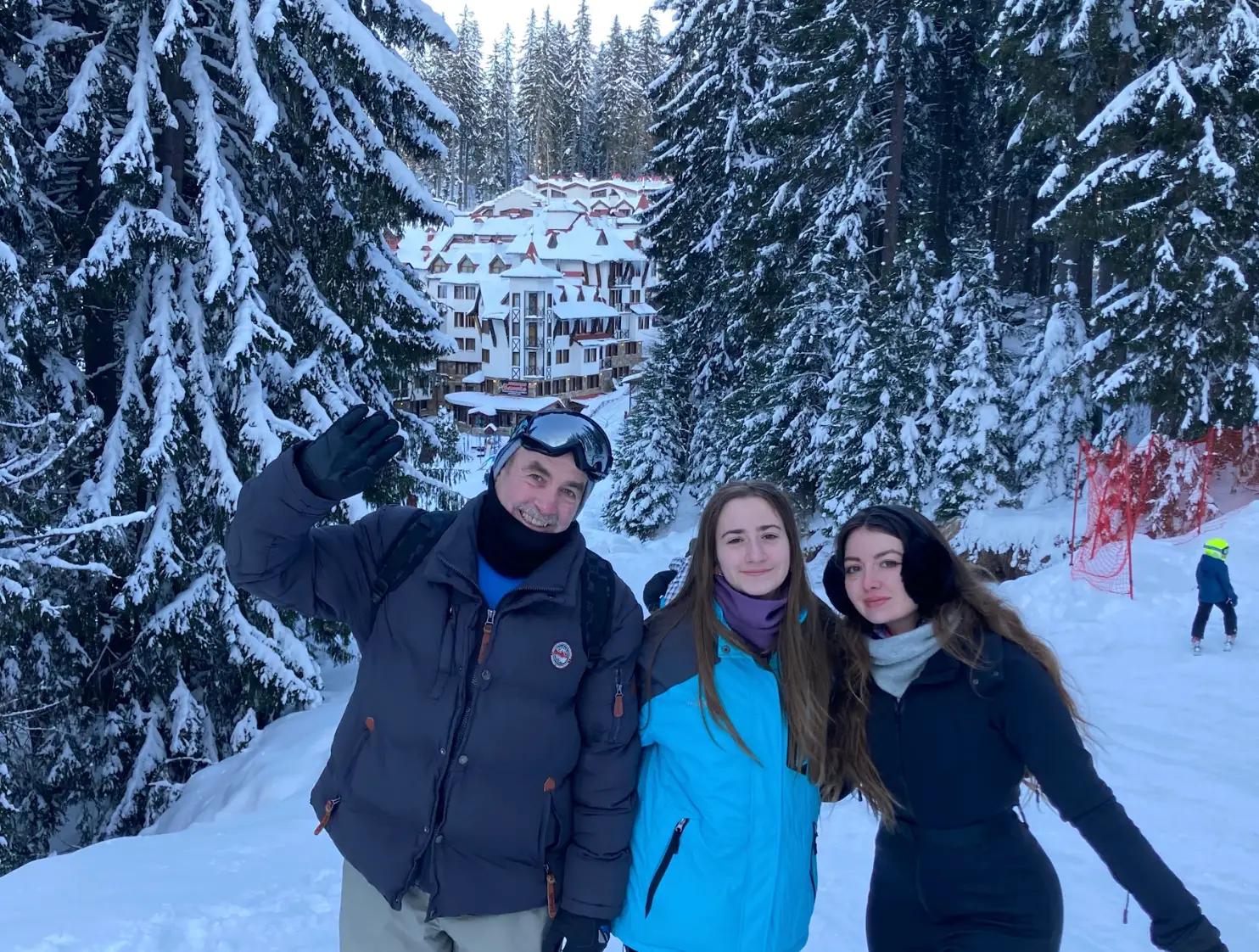 The writer posing while skiing with her dad and sister.
