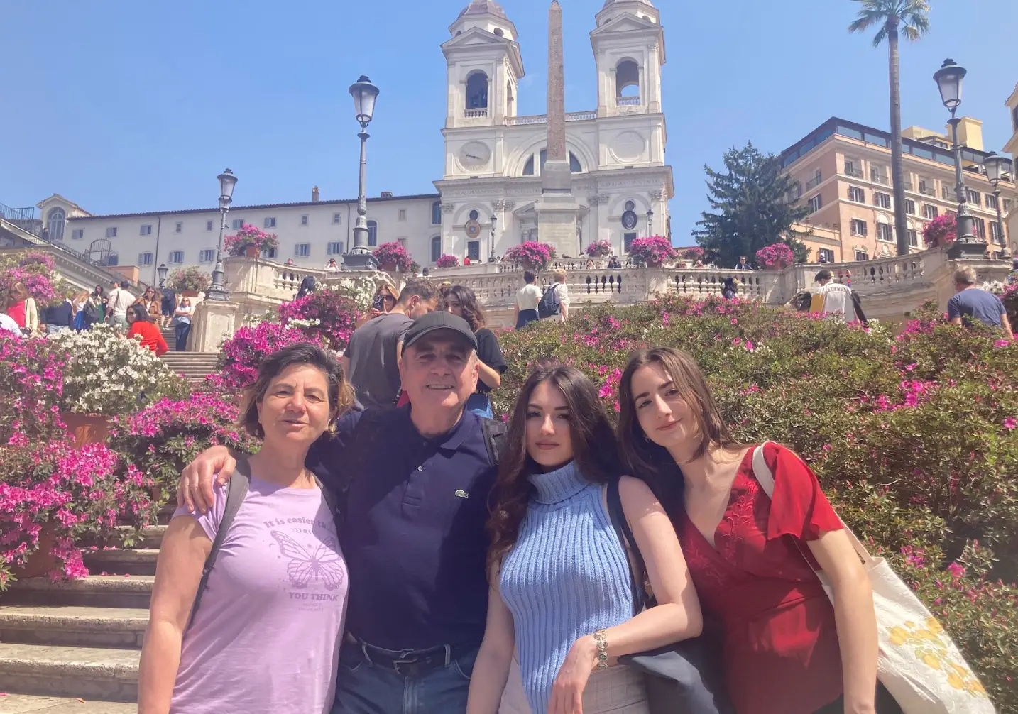 The writer posing on vacation with her parents and sister.