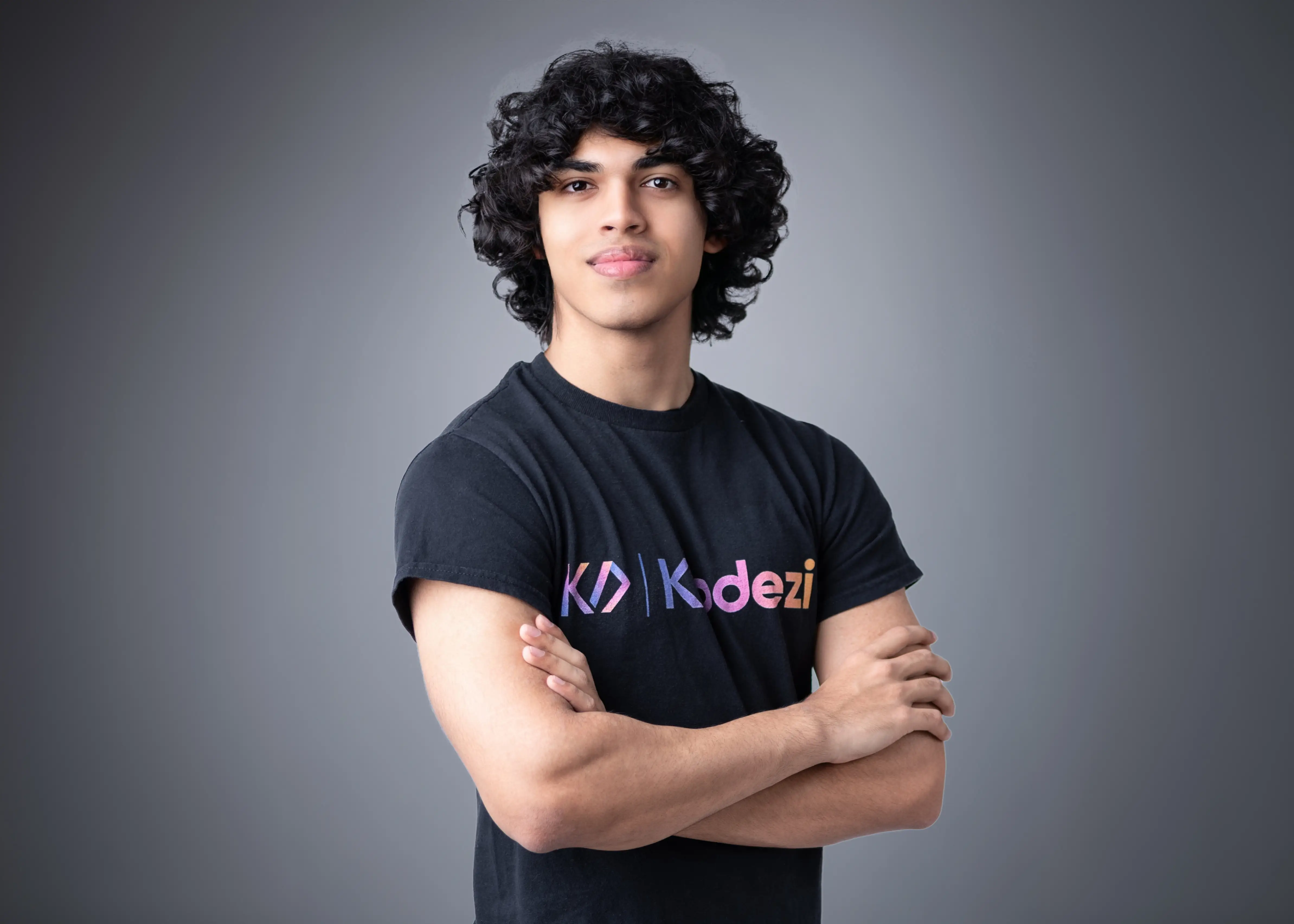 headshot of a man in front of a gray background