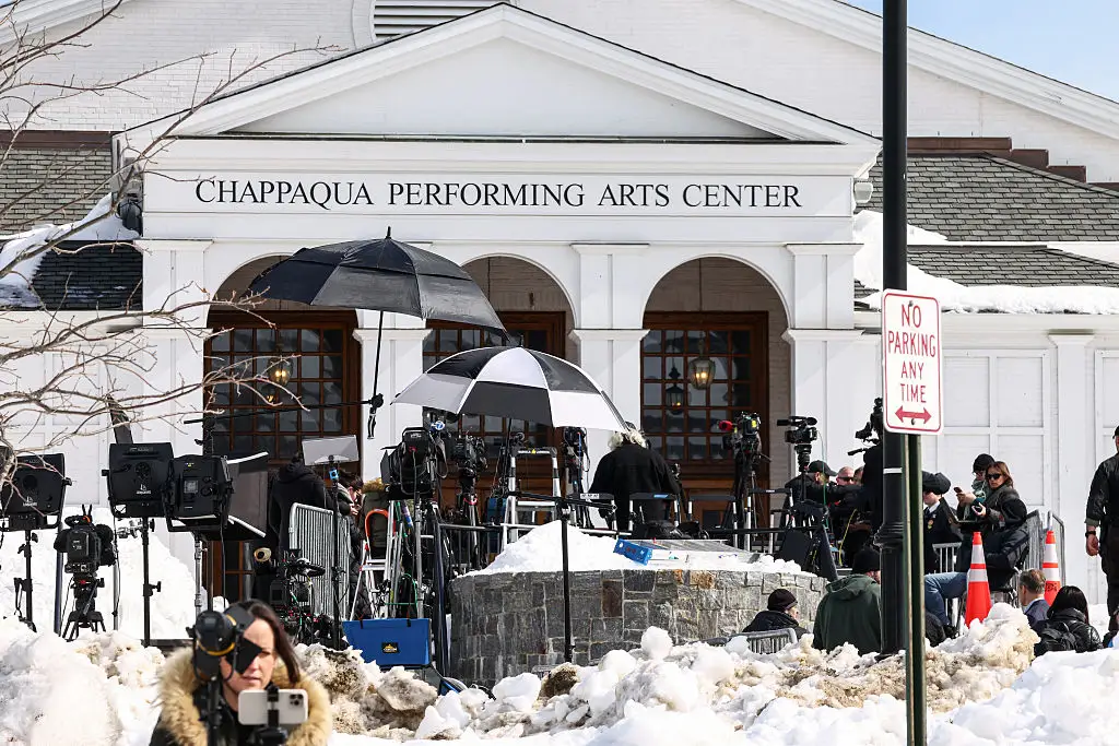 Members of the media gather outside the Chappaqua Performing Arts Center as members of the House Oversight Committee conduct a deposition with Hillary Clinton.