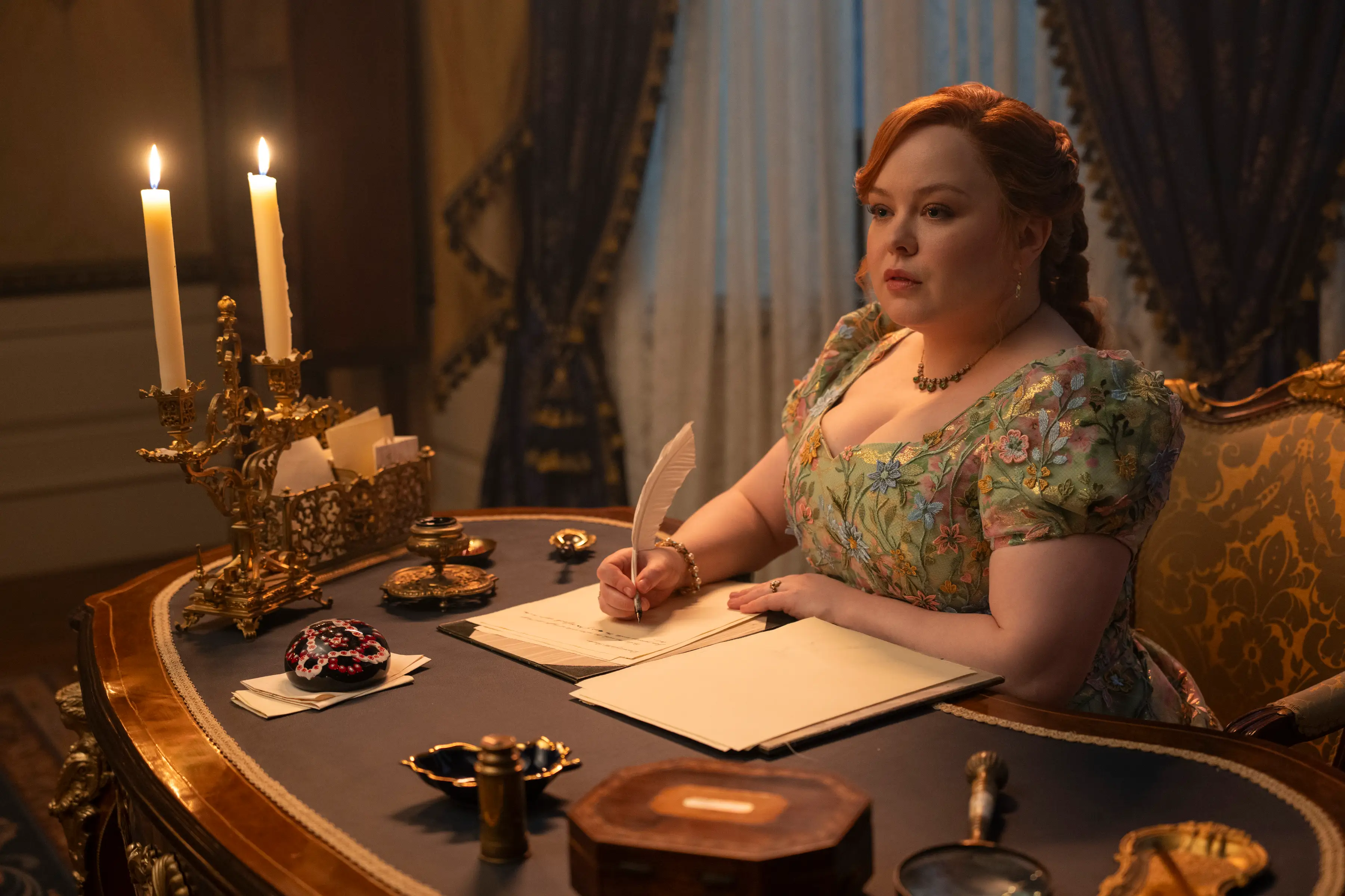 Penelope writing at her desk.