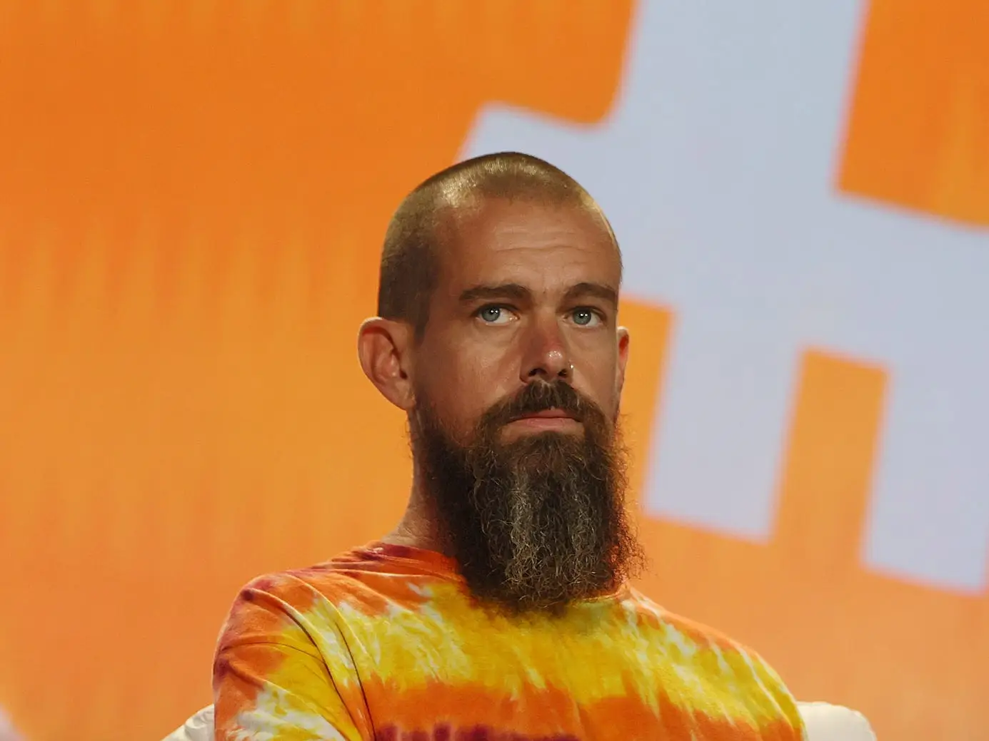 Jack Dorsey headshot orange background
