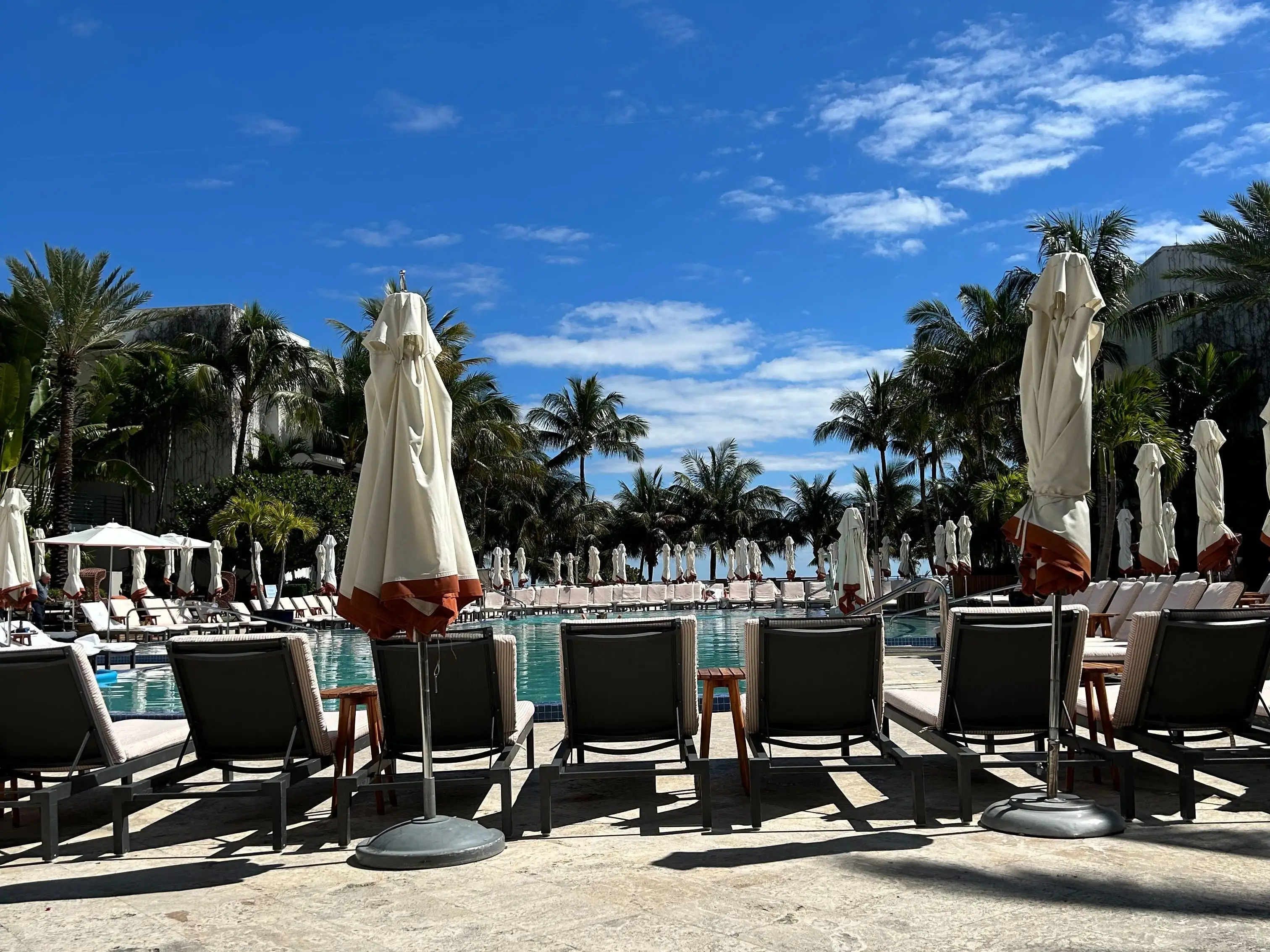 A hotel pool set against blue skies
