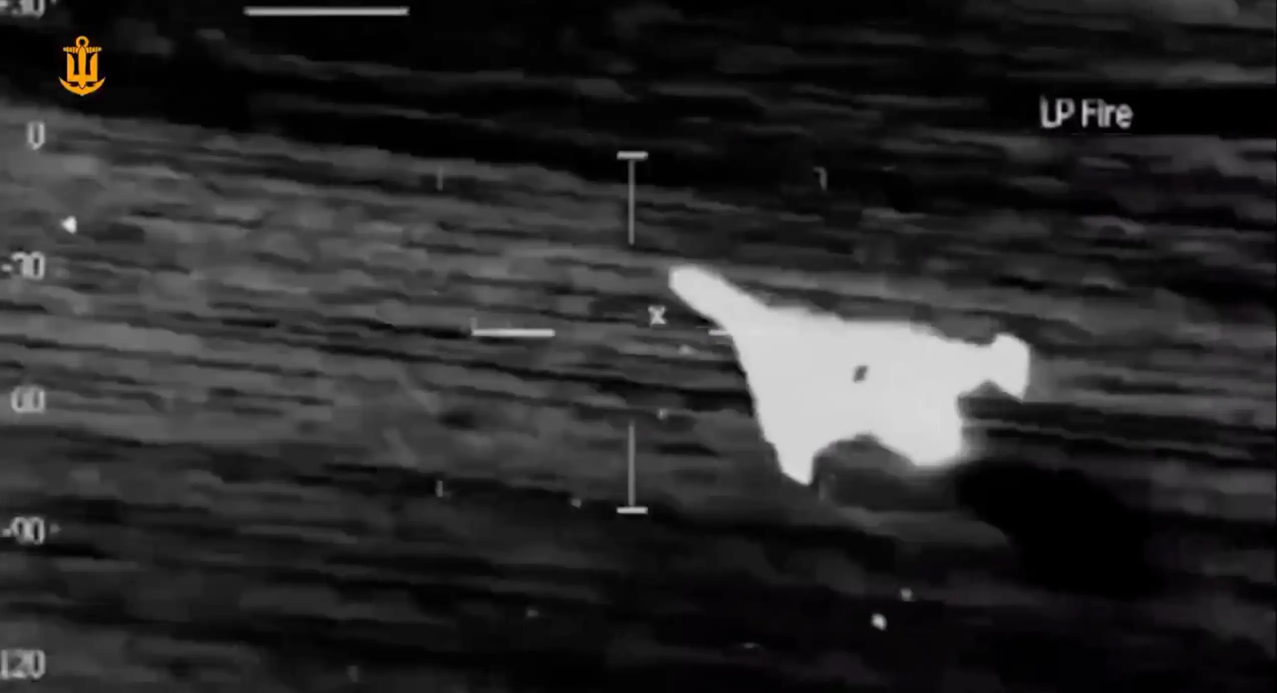Thermal imagery from a gun camera aimed at a delta-wing drone.