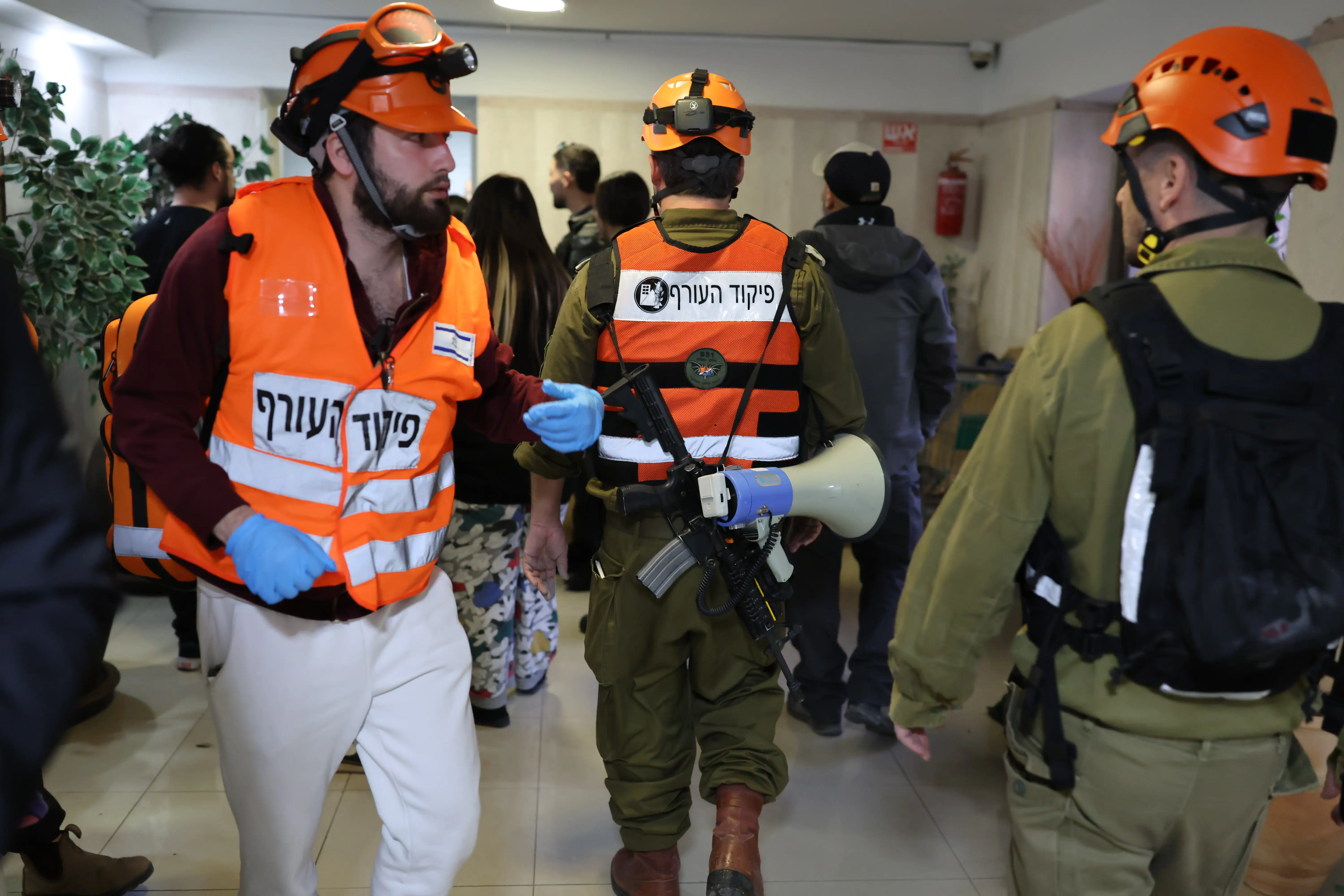 Rescue workers arrive on the scene after shrapnel from an intercepted Iranian missile landed on a building in Ramat Gan.
