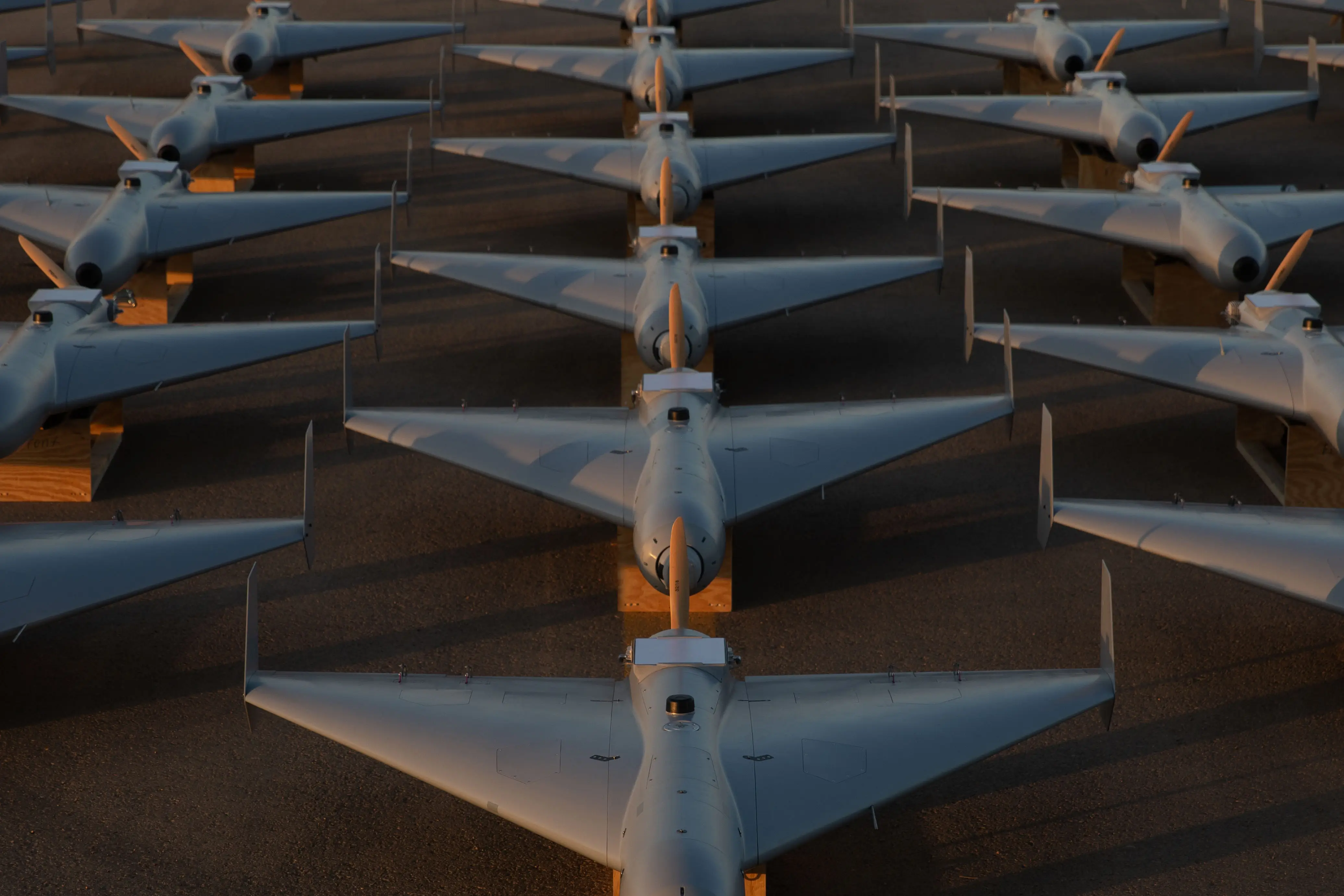 Cheap US military drones are positioned on the tarmac.