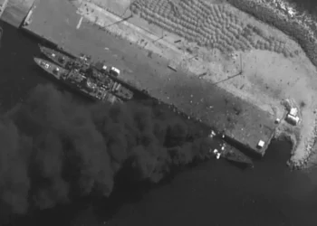 Satellite images show an Iranian warship burning pierside after US and Israeli strikes