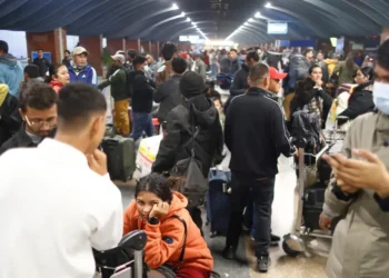 Photos show chaos at airports as passengers are left stranded due to canceled flights