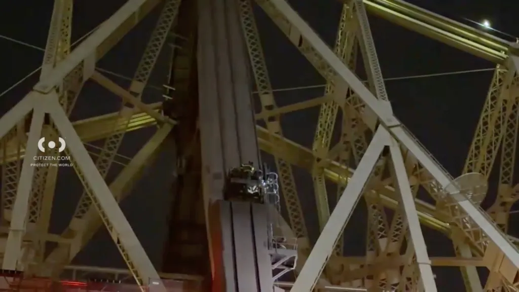 First responders on a platform on a bridge column during a rescue operation.