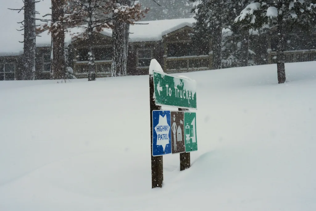 Snow-covered signs pointing 